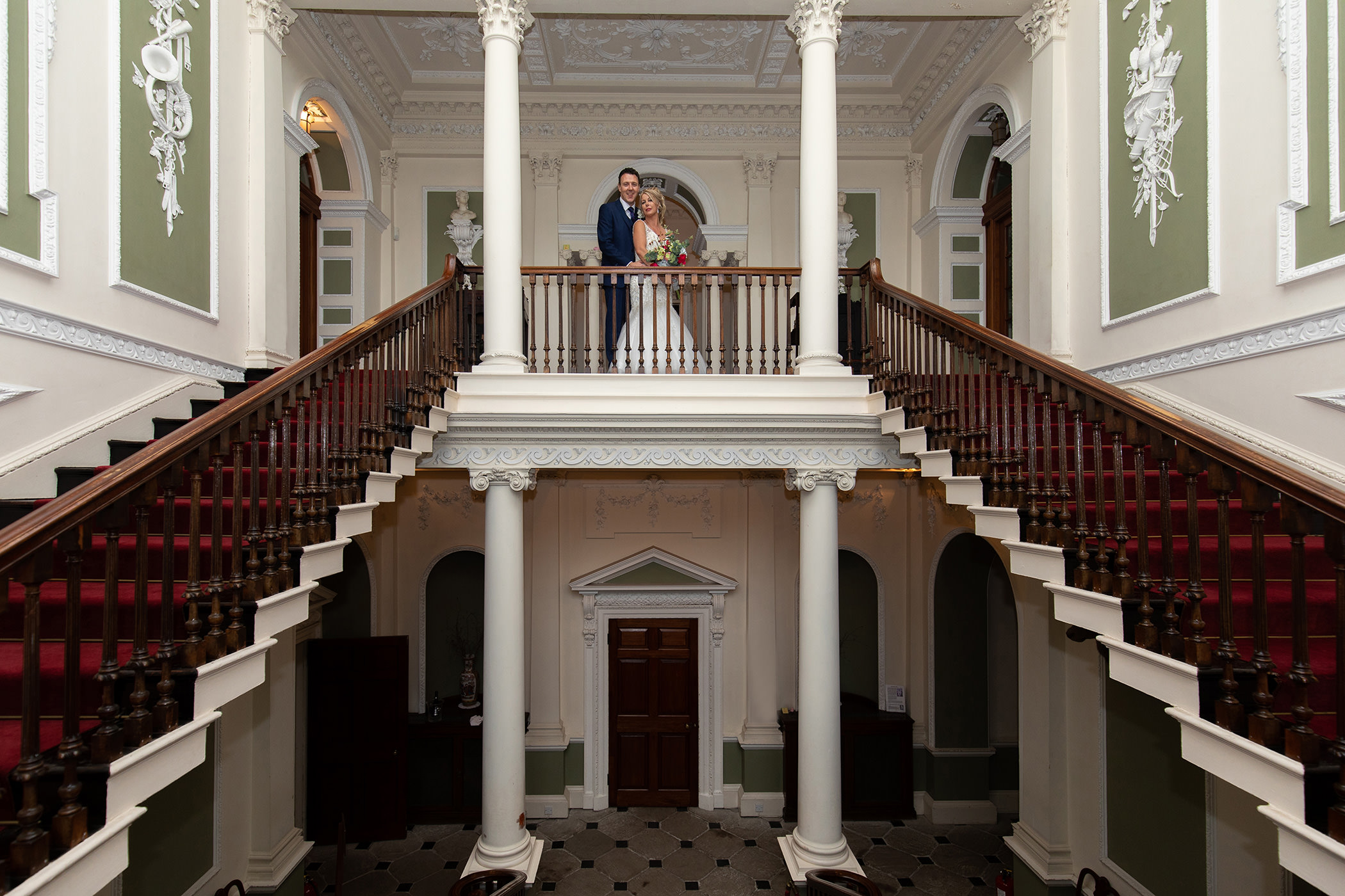 the bride and groom on the stair case
