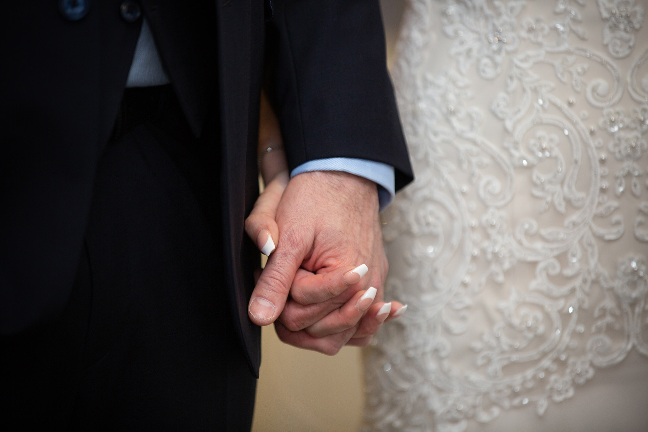 the bride and groom holding hands