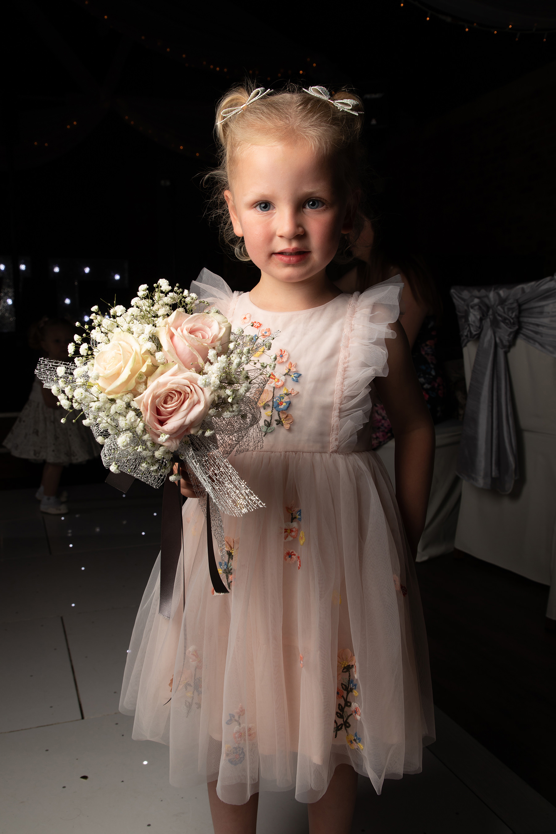 little girl holding the bouquet 