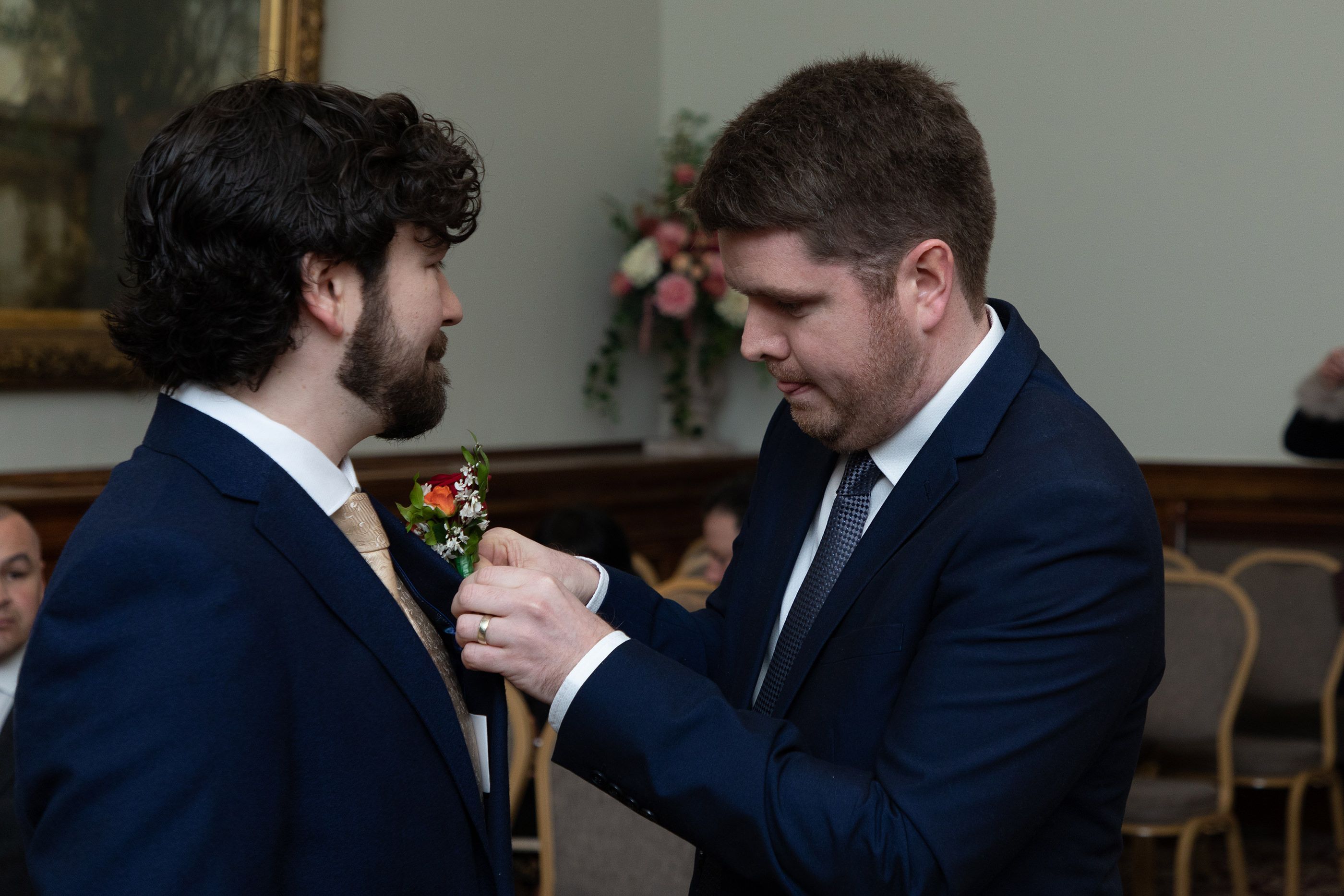 the best man fixing the flowers