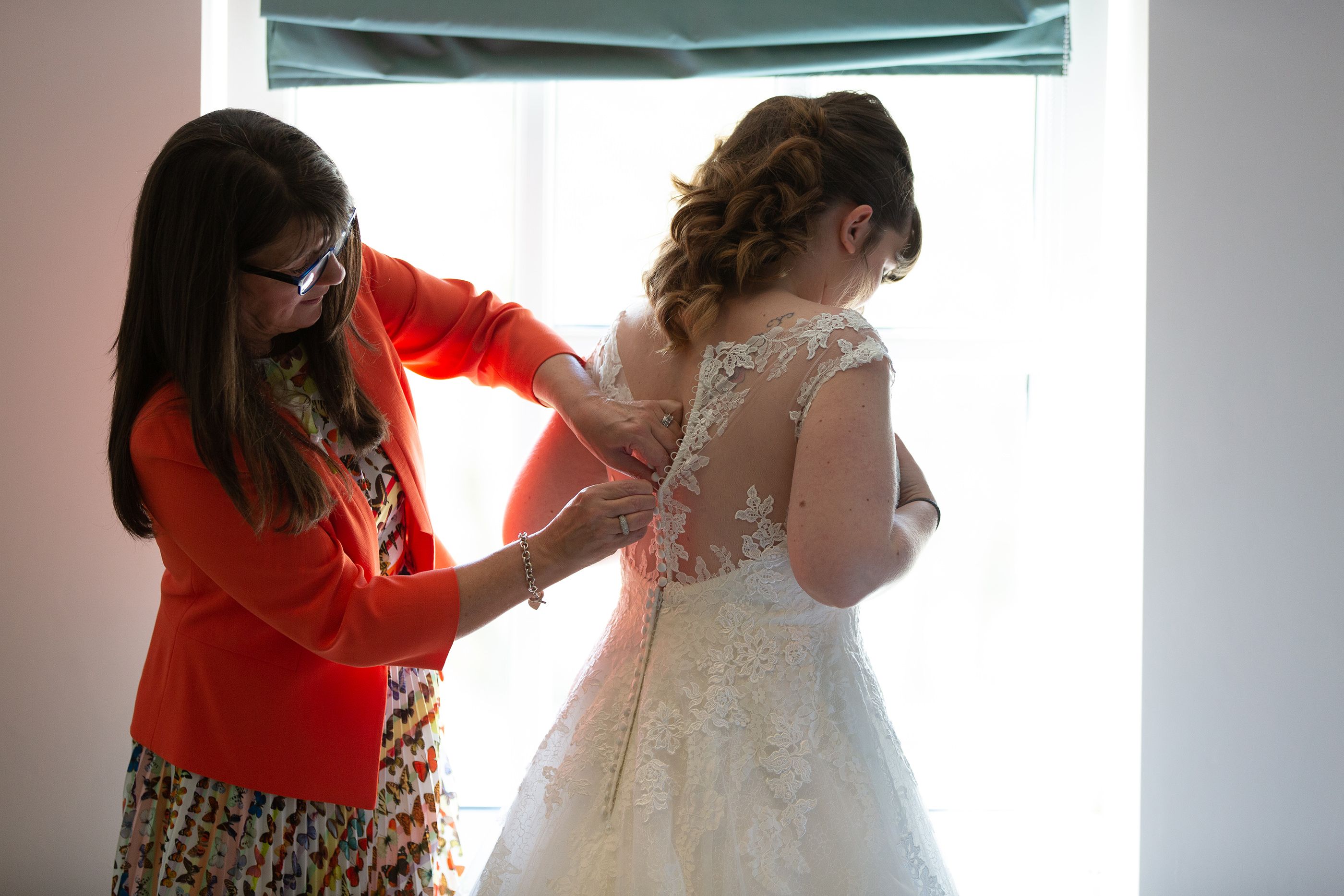 putting on the wedding dress