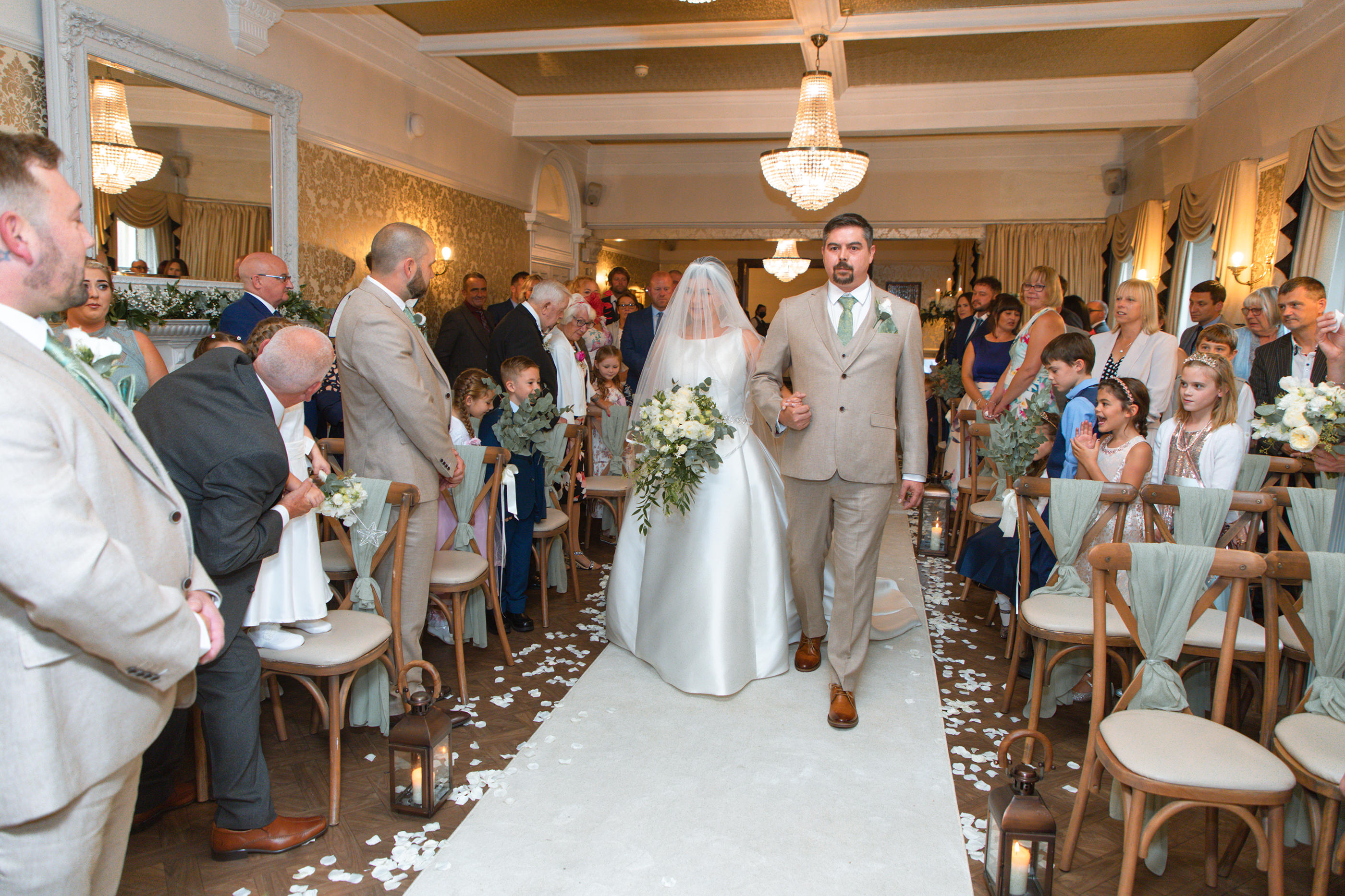 Becky walks into the ceremony room for her wedding 