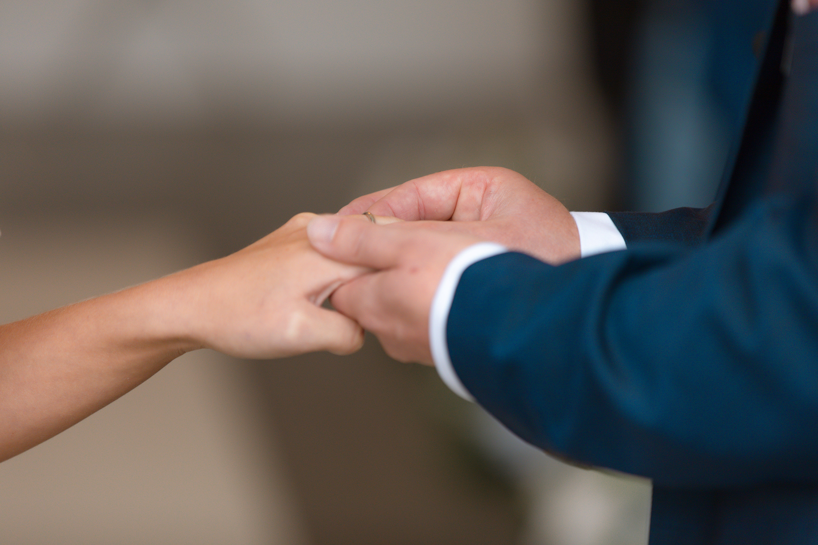 The bride and groom exchange wedding rings 