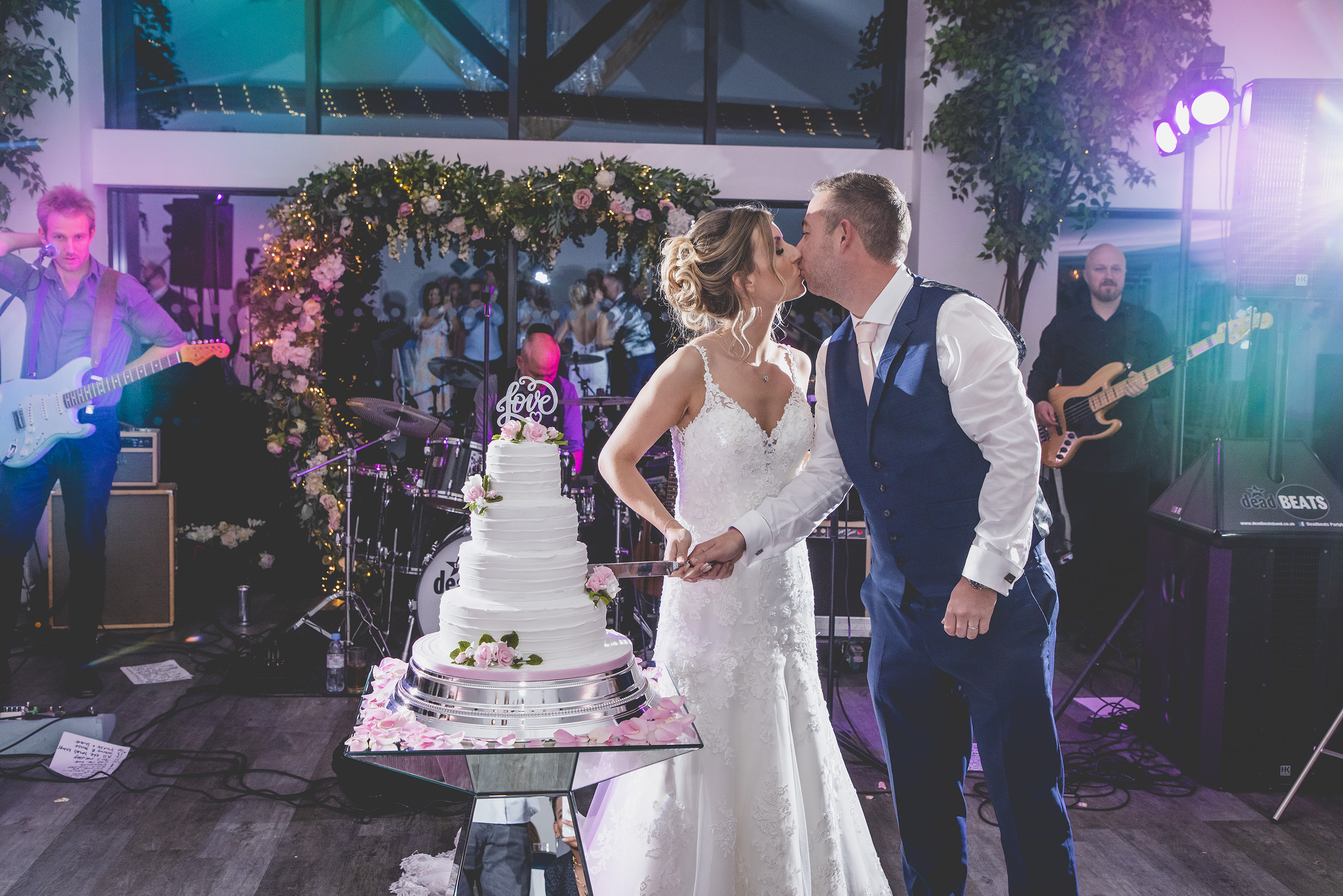 The bride and groom cut the wedding cake 