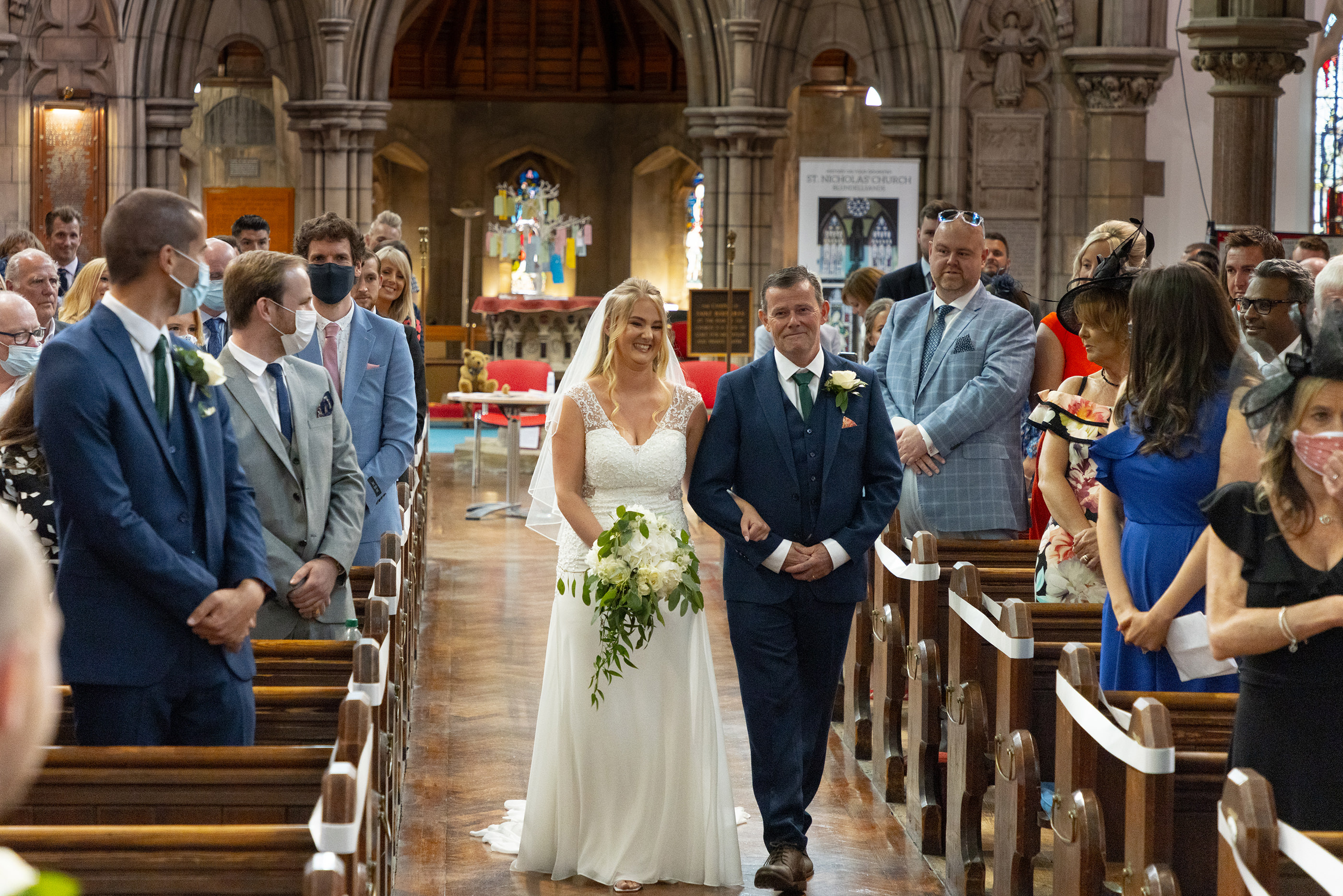 father and daughter walk up the church isle