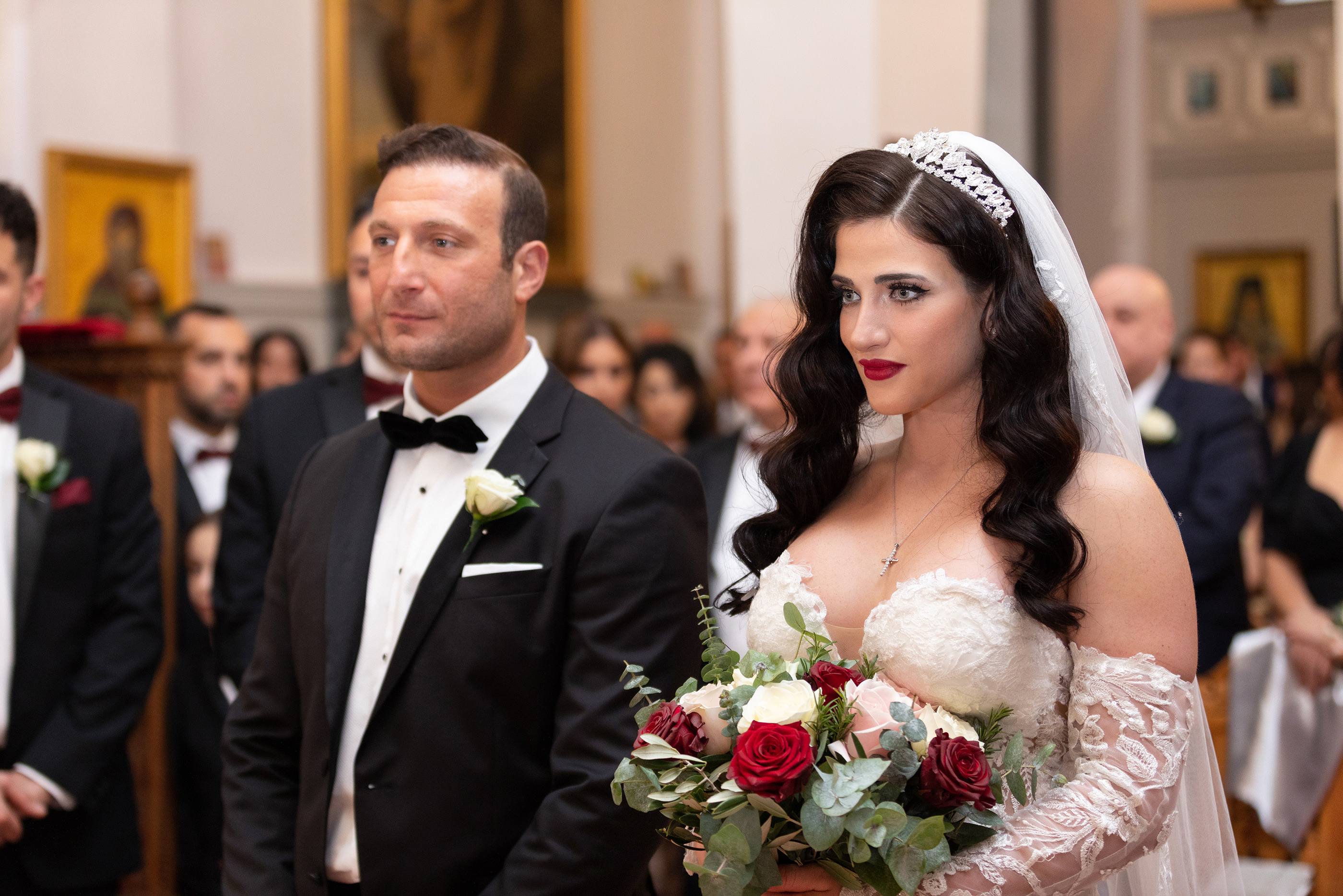  the bride and groom standing at the wedding ceremony
