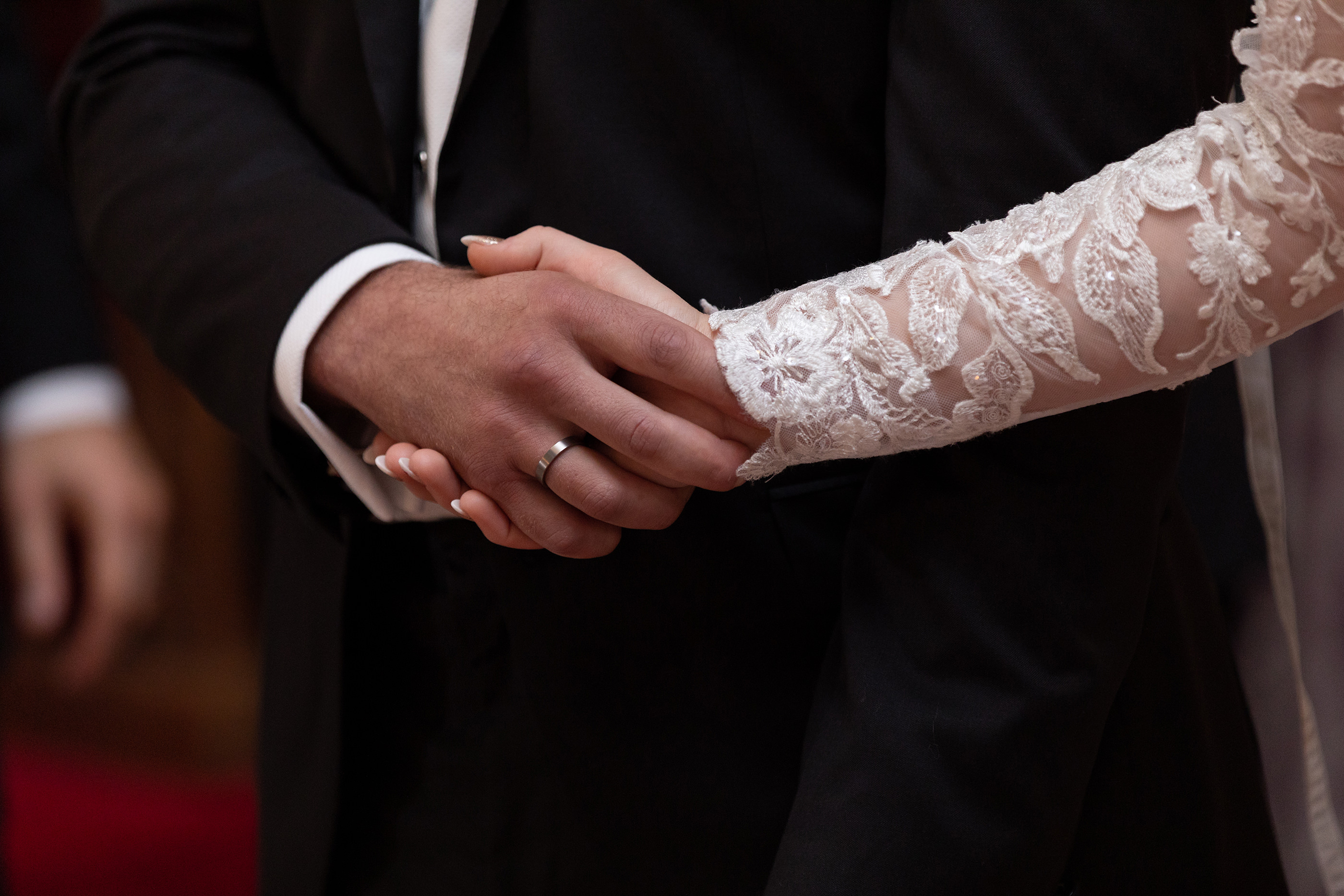  the bride and groom hold hands