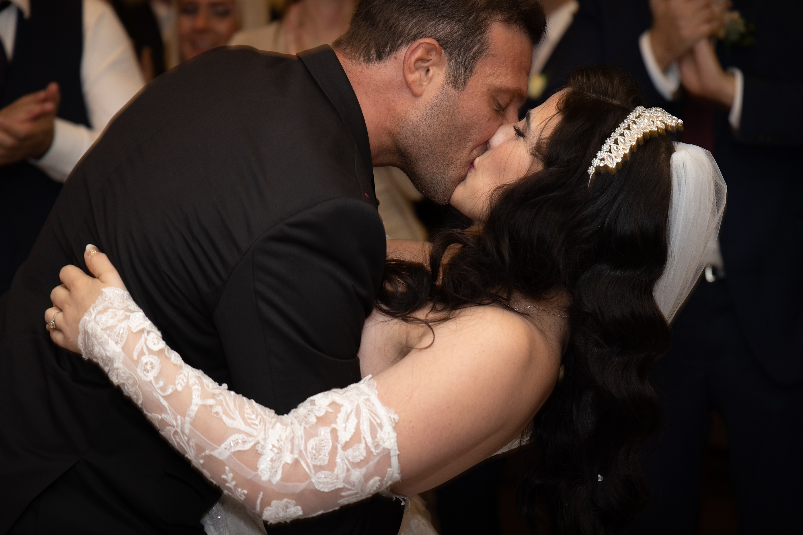  the bride and groom kiss on the dance floor
