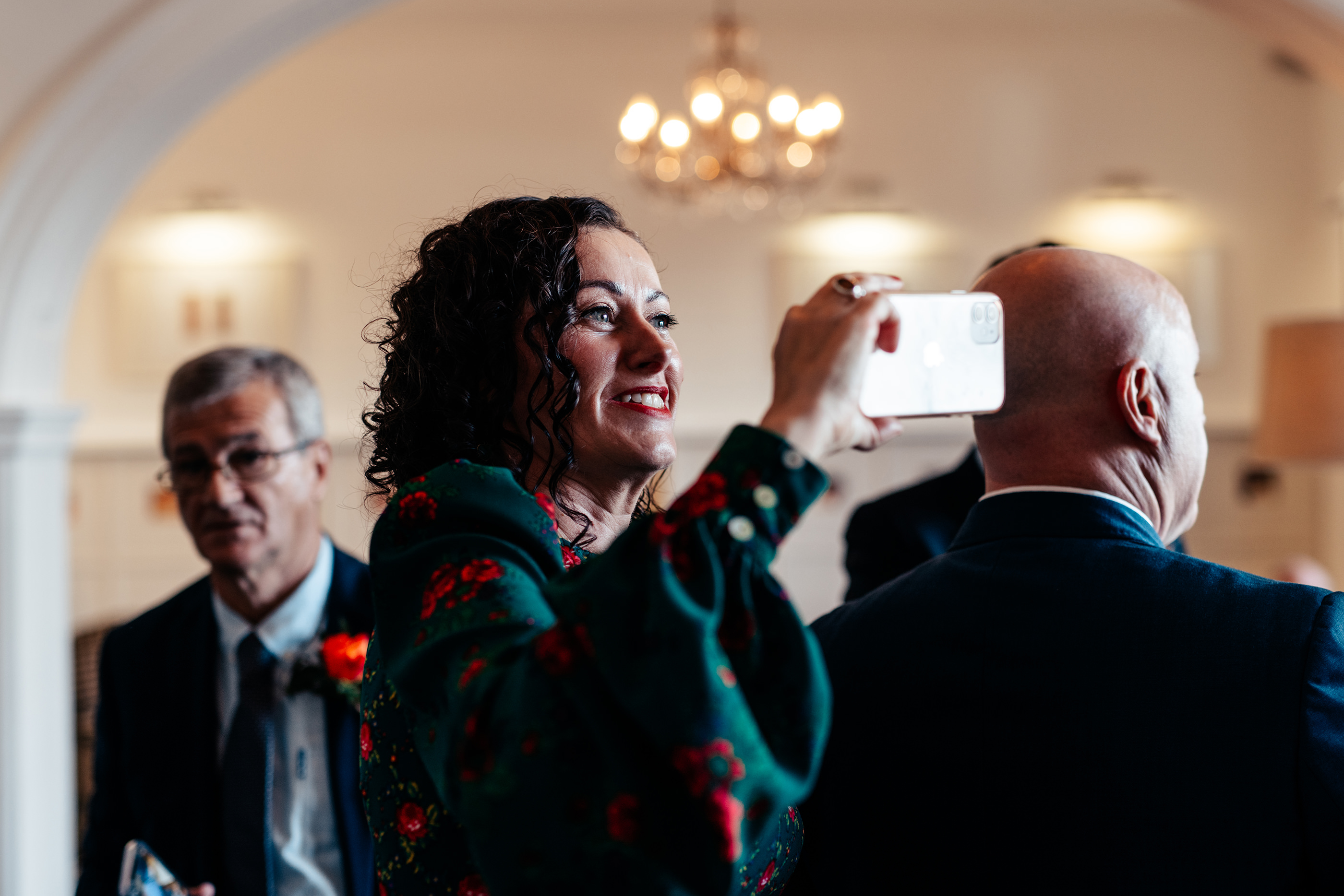   wedding guests taking photos on their phone