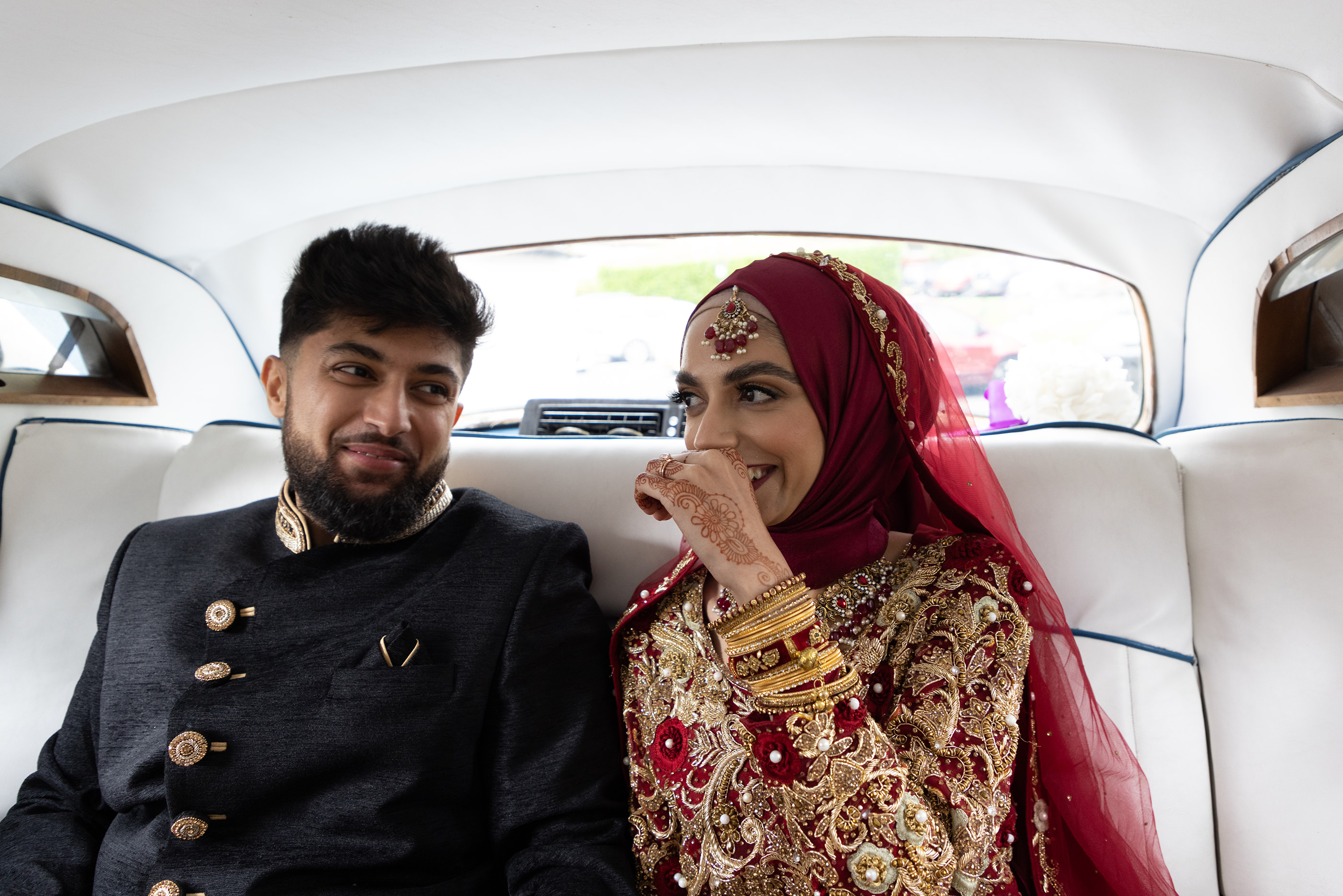 the happy couple in the wedding car
