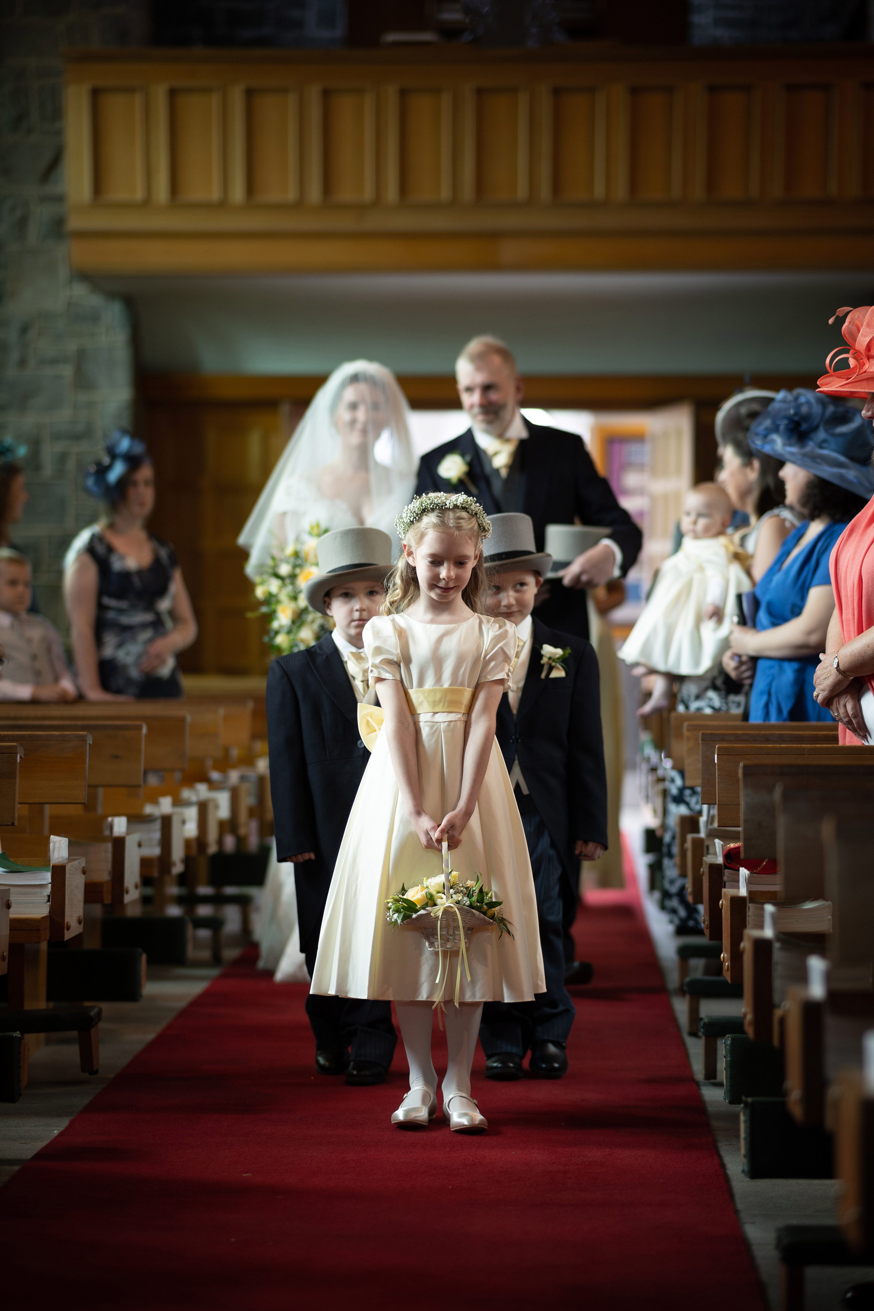 The flower girl walking slowly down the aisle