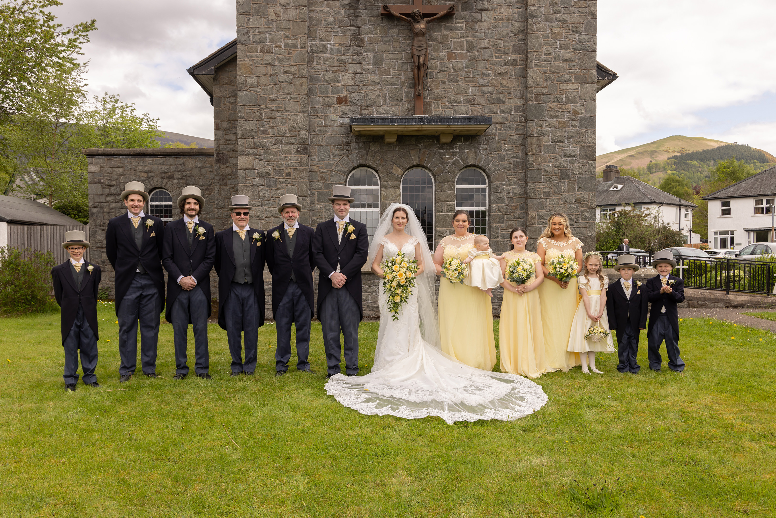 The bride and groom with the groomsmen and bridesmaids for a photo