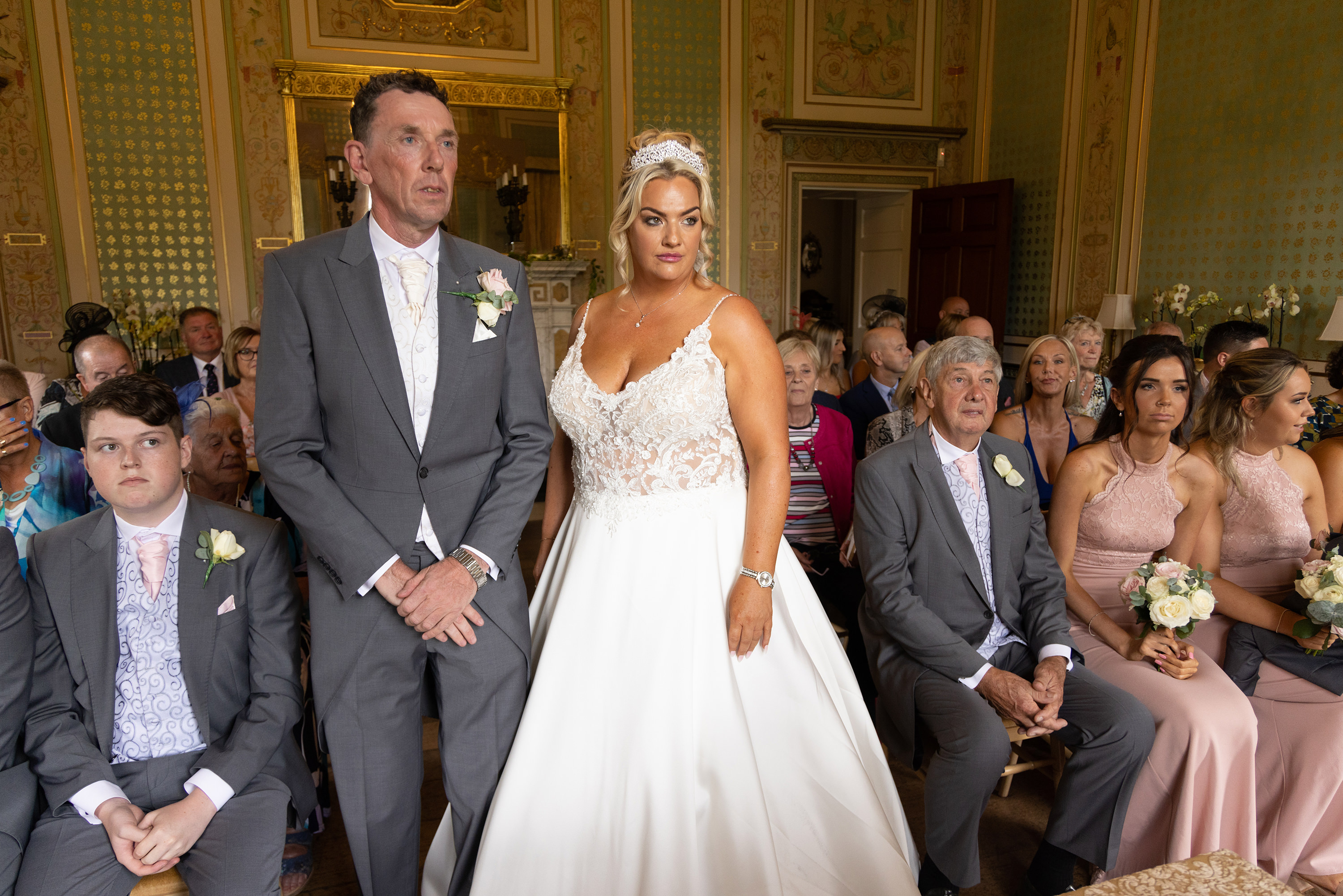 The happy couple stand hand in hand