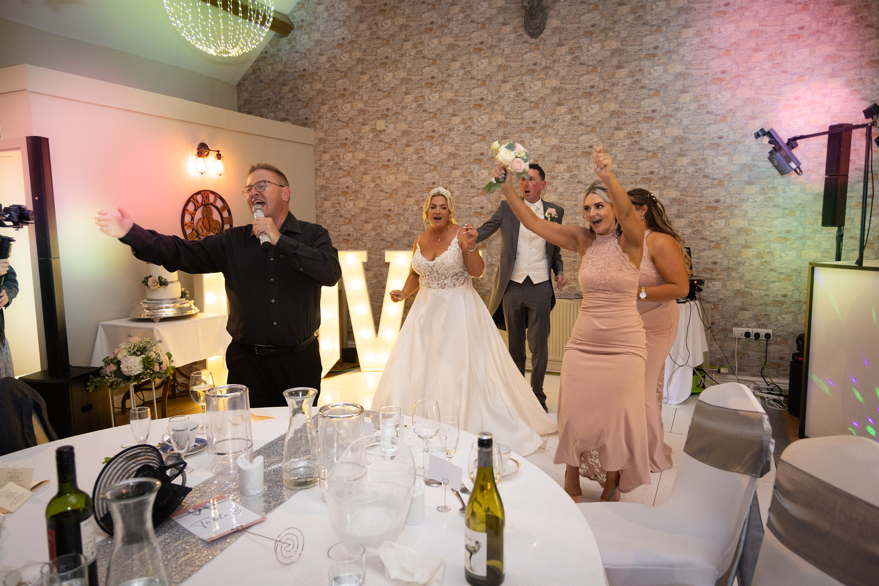 The bride and groom enjoying the singing waiters at Lytham Hall 