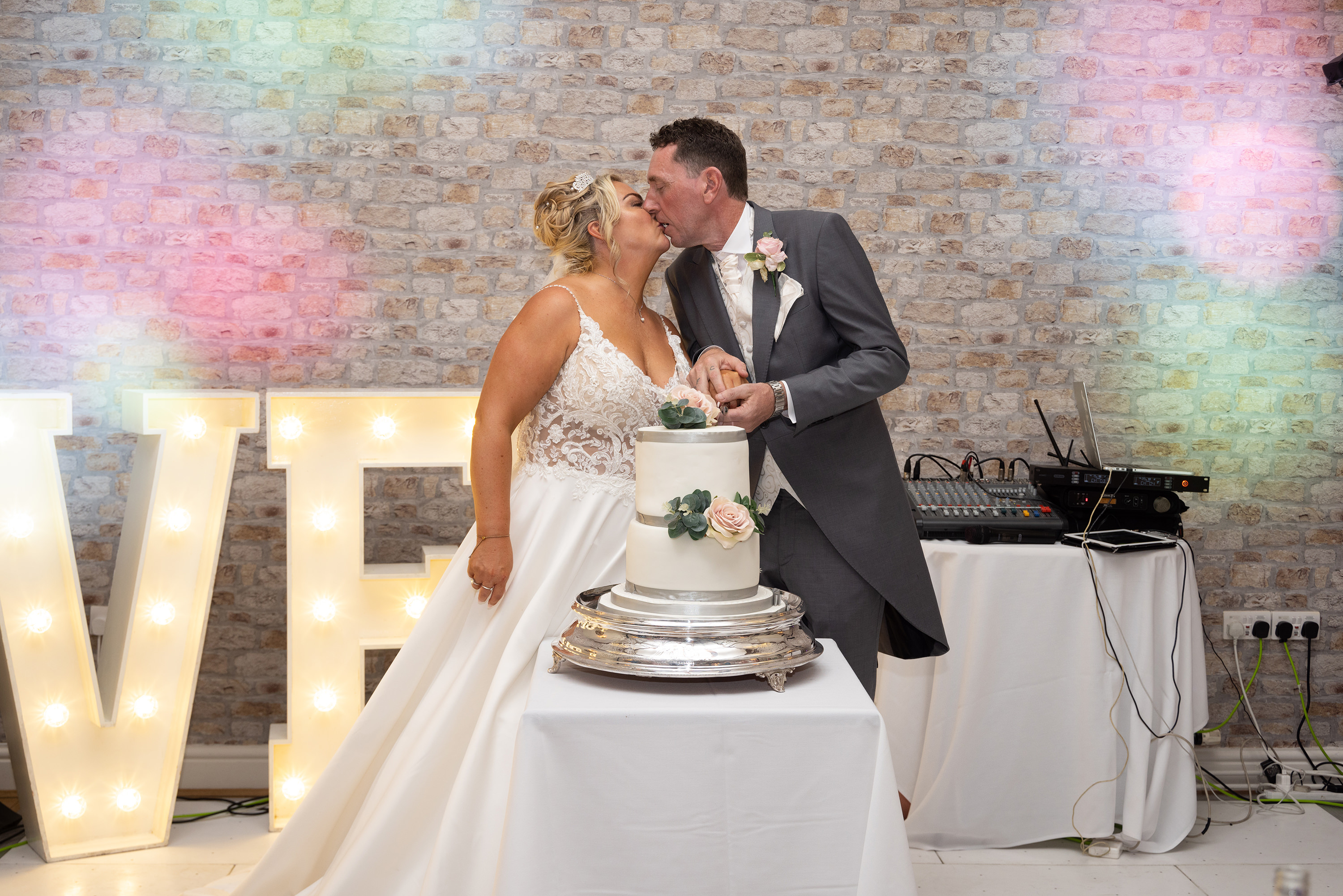 The bride and groom cut their wedding cake 