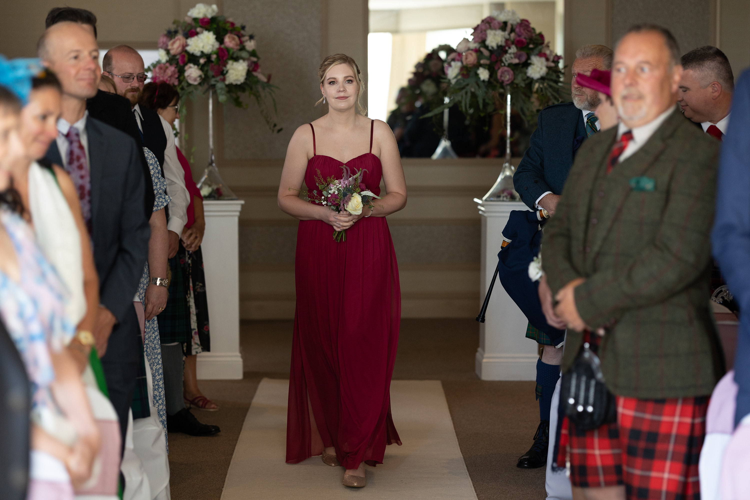 The bridesmaids walk down the aisle 