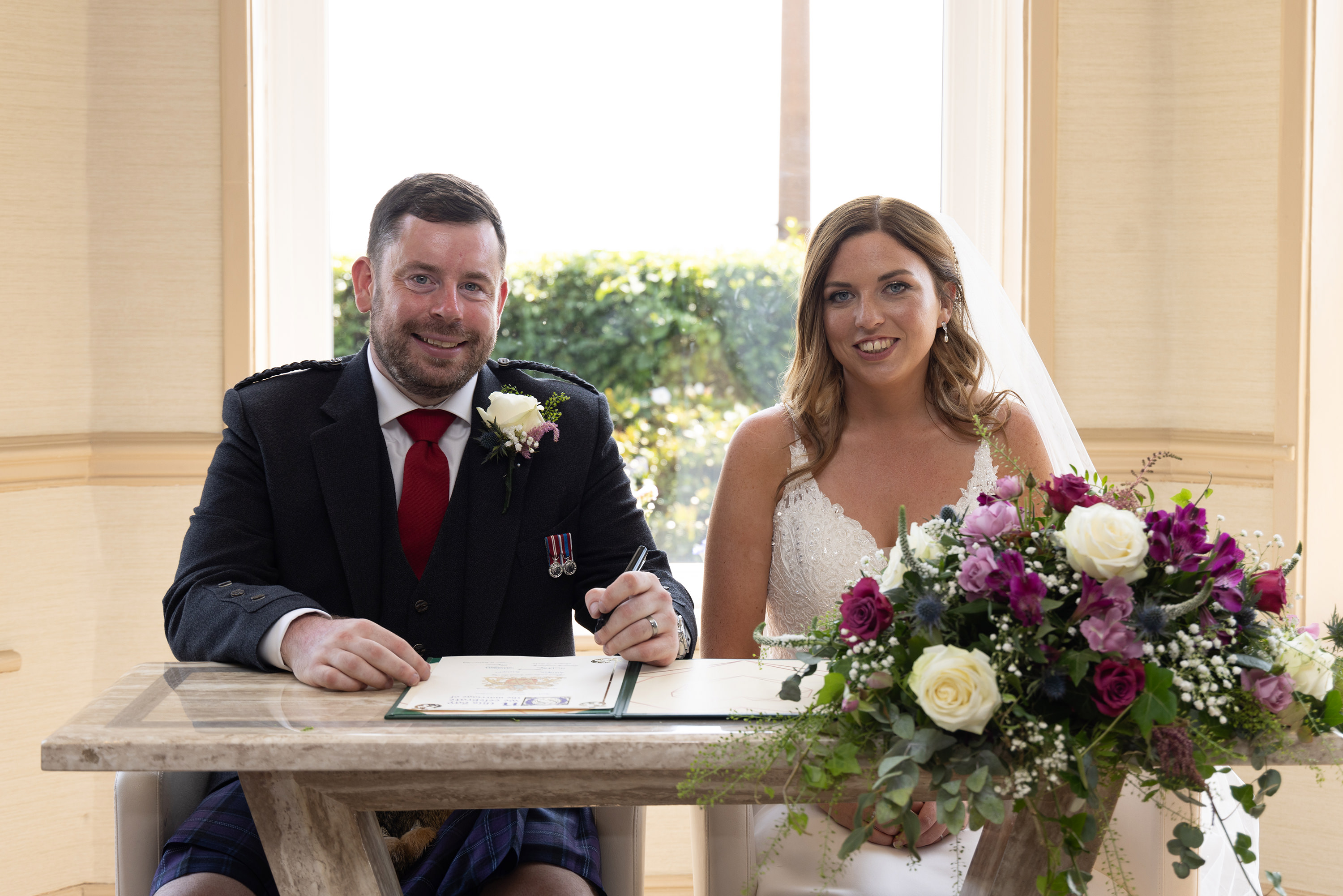 Andrew and Beverly sign the wedding register