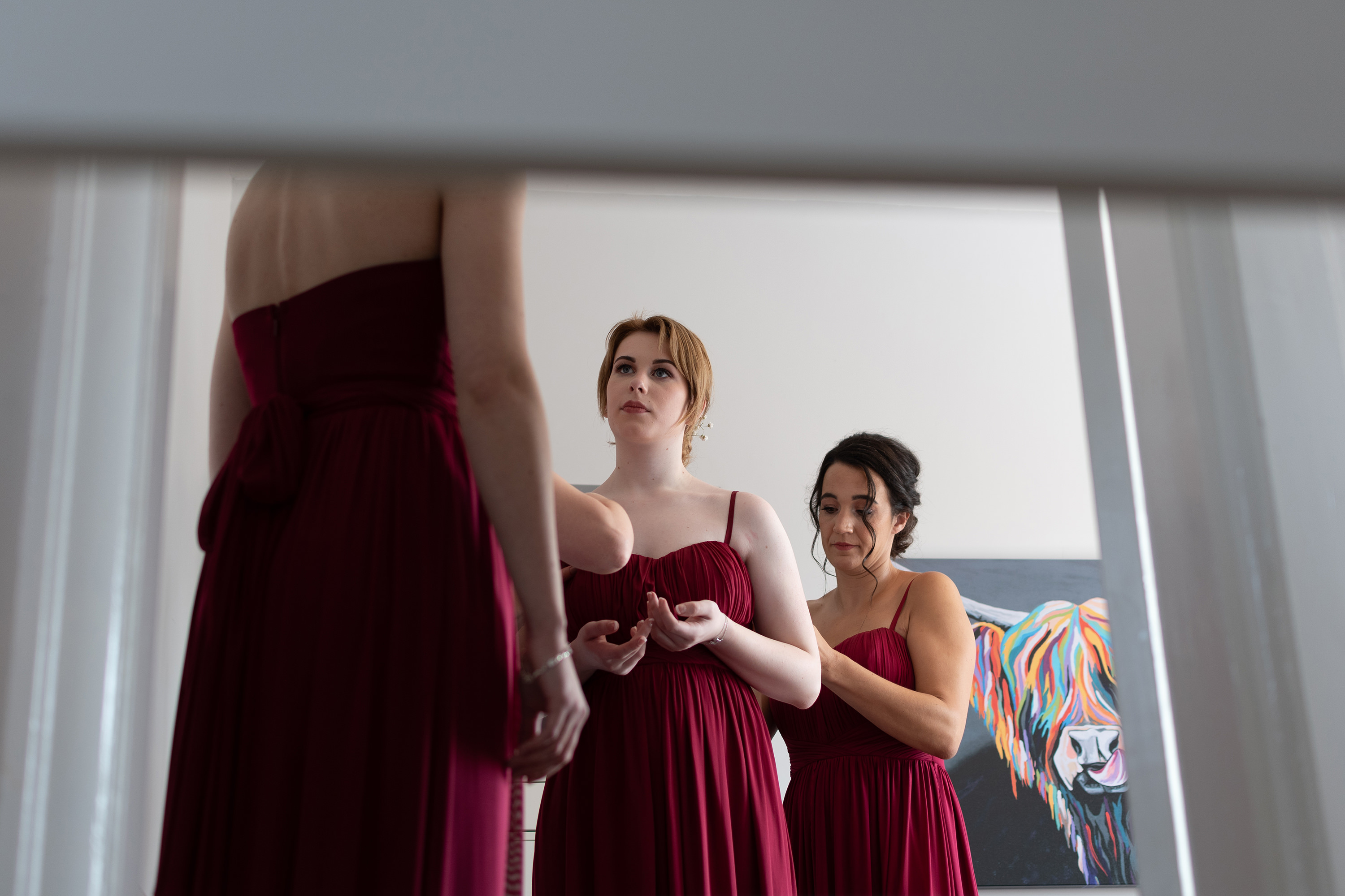 The bridesmaids putting on their dresses 