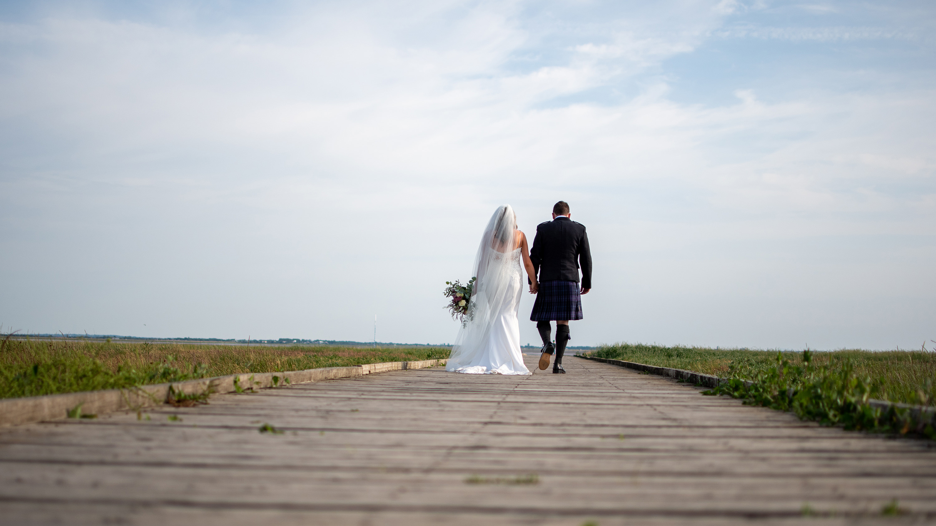 The bride and groom take a walk down Lytham jetty 