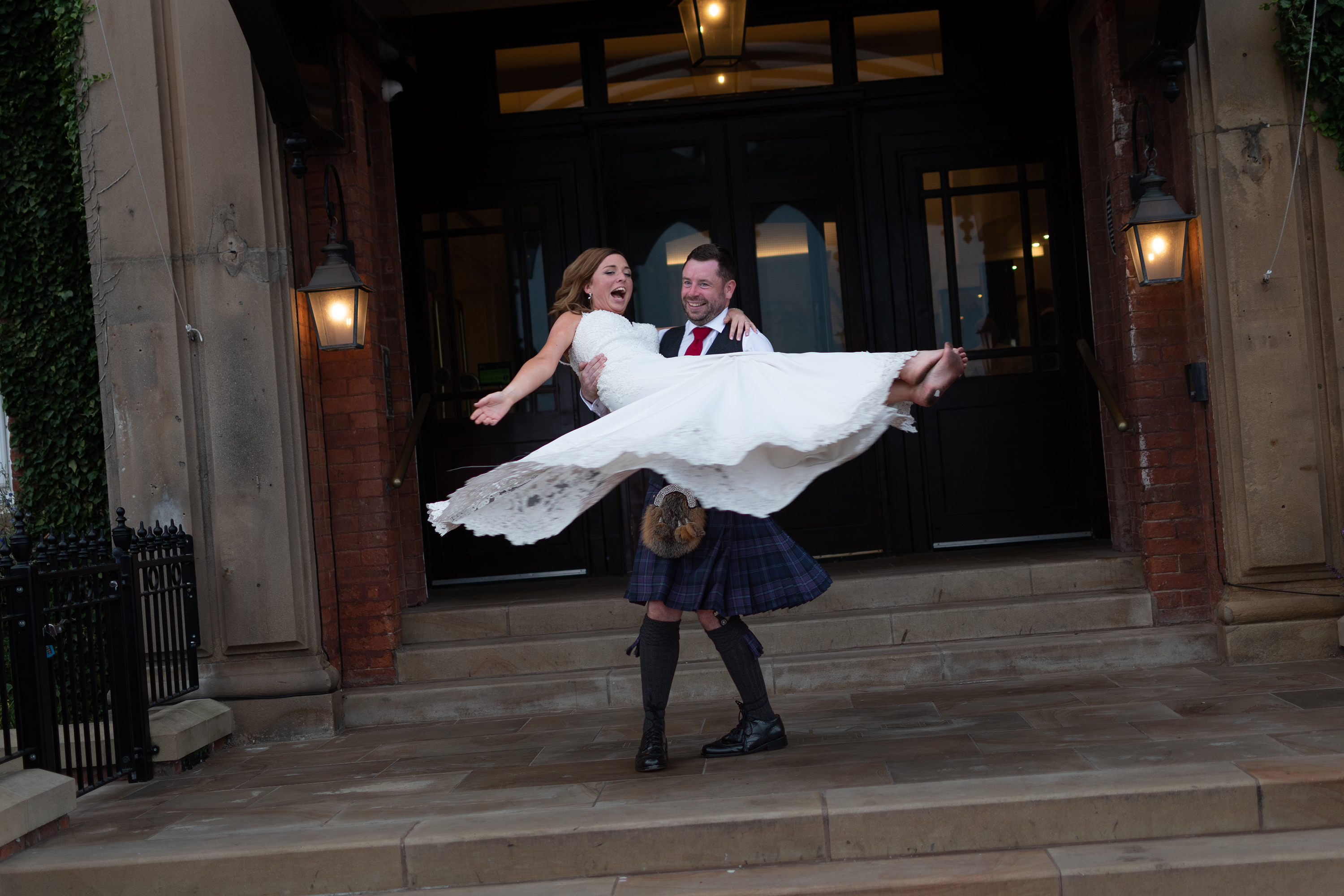 Andrew spins his wife around on the steps of the Clifton Arms 