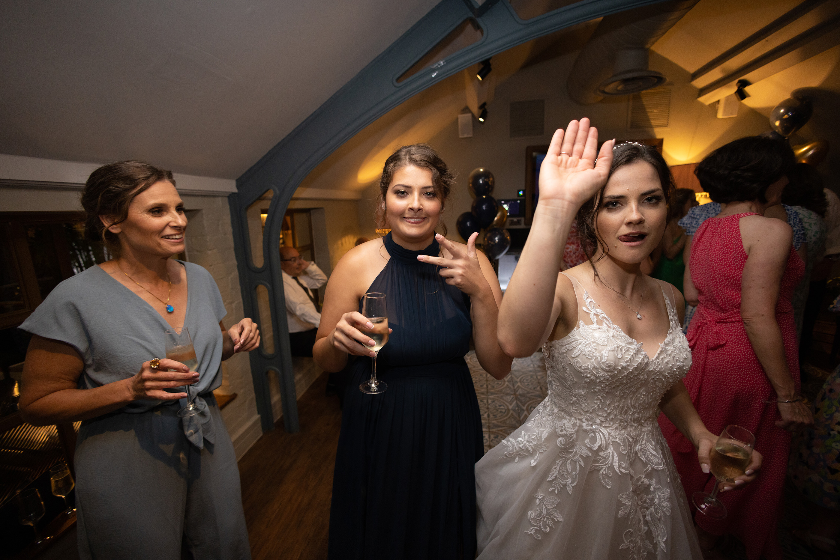 the bride her sister and mother enjoying the party