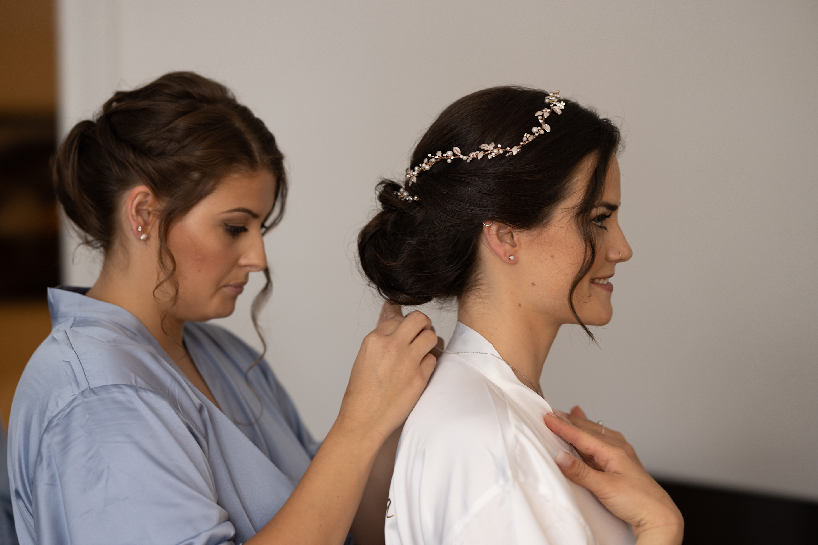 The Brides sister putting on Chelsea's necklace
