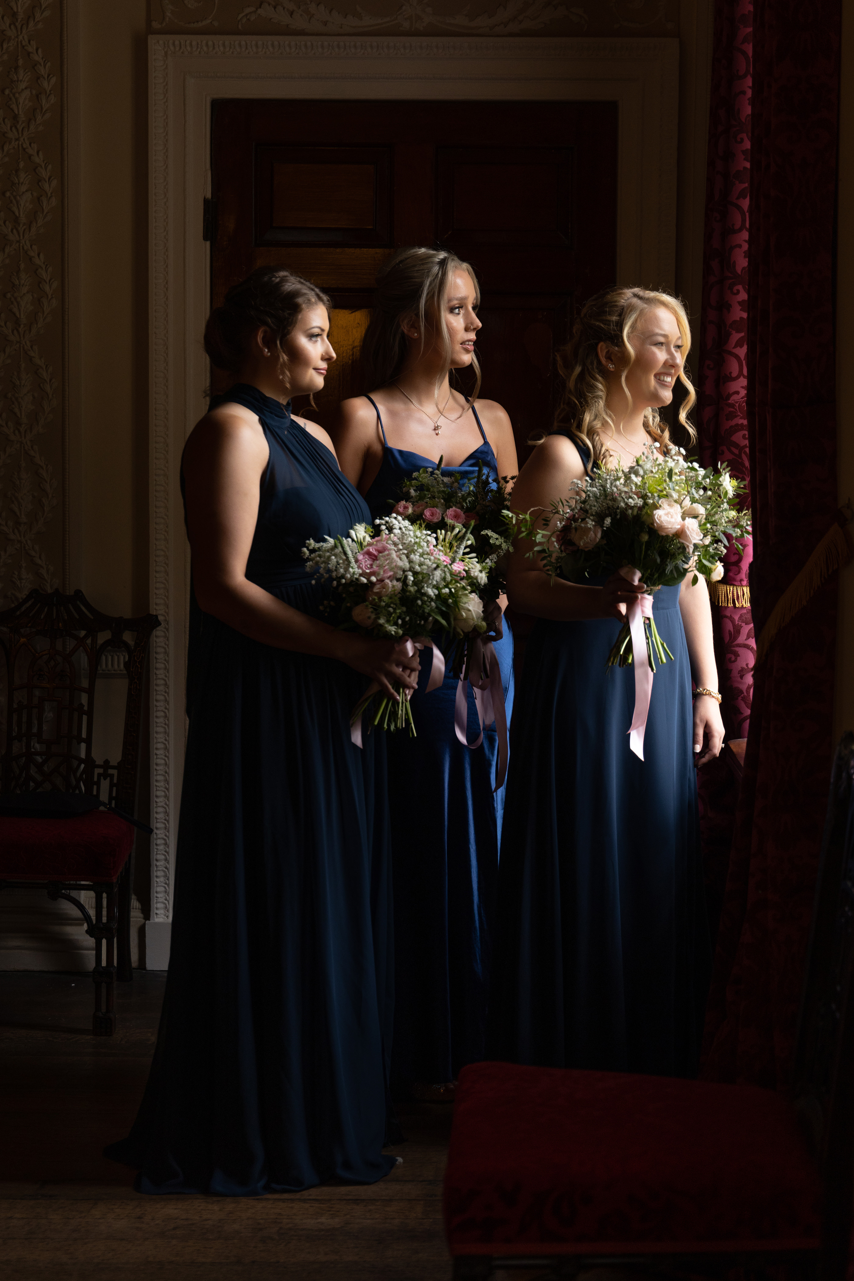 The bridesmaids looking out the window at Lytham Hall 