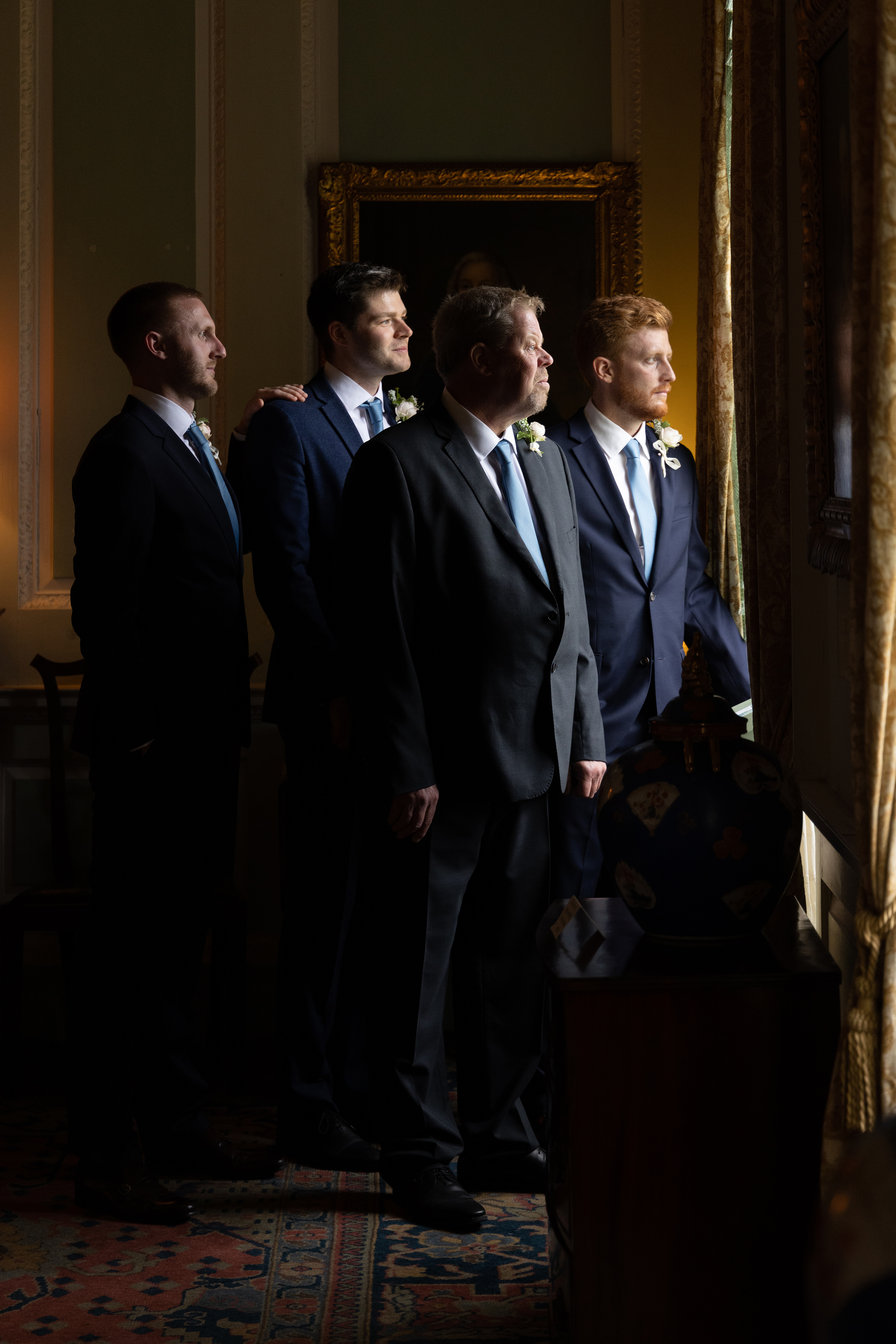 The groomsmen looking out of the window 
