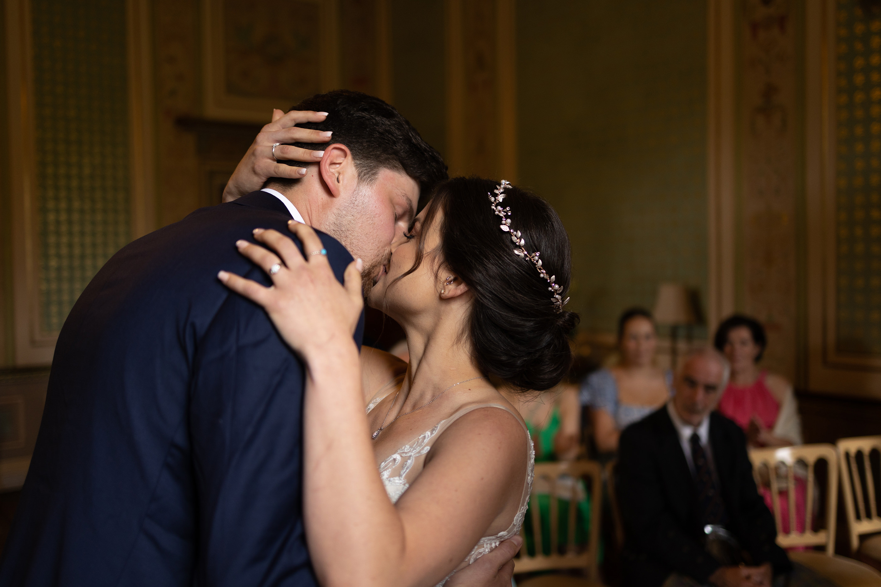 The bride and groom still their wedding with a kiss 