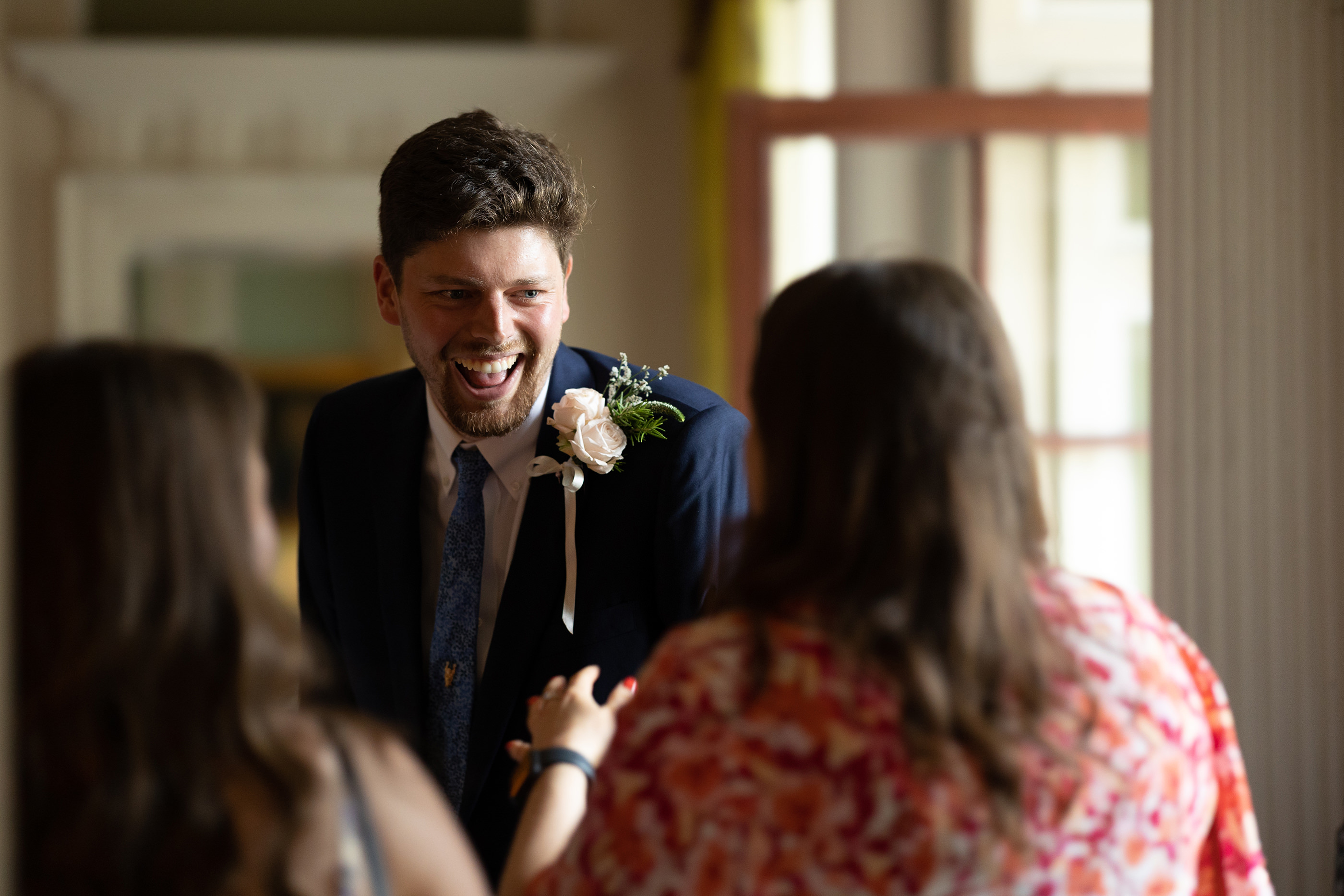 The groom laughing with friends