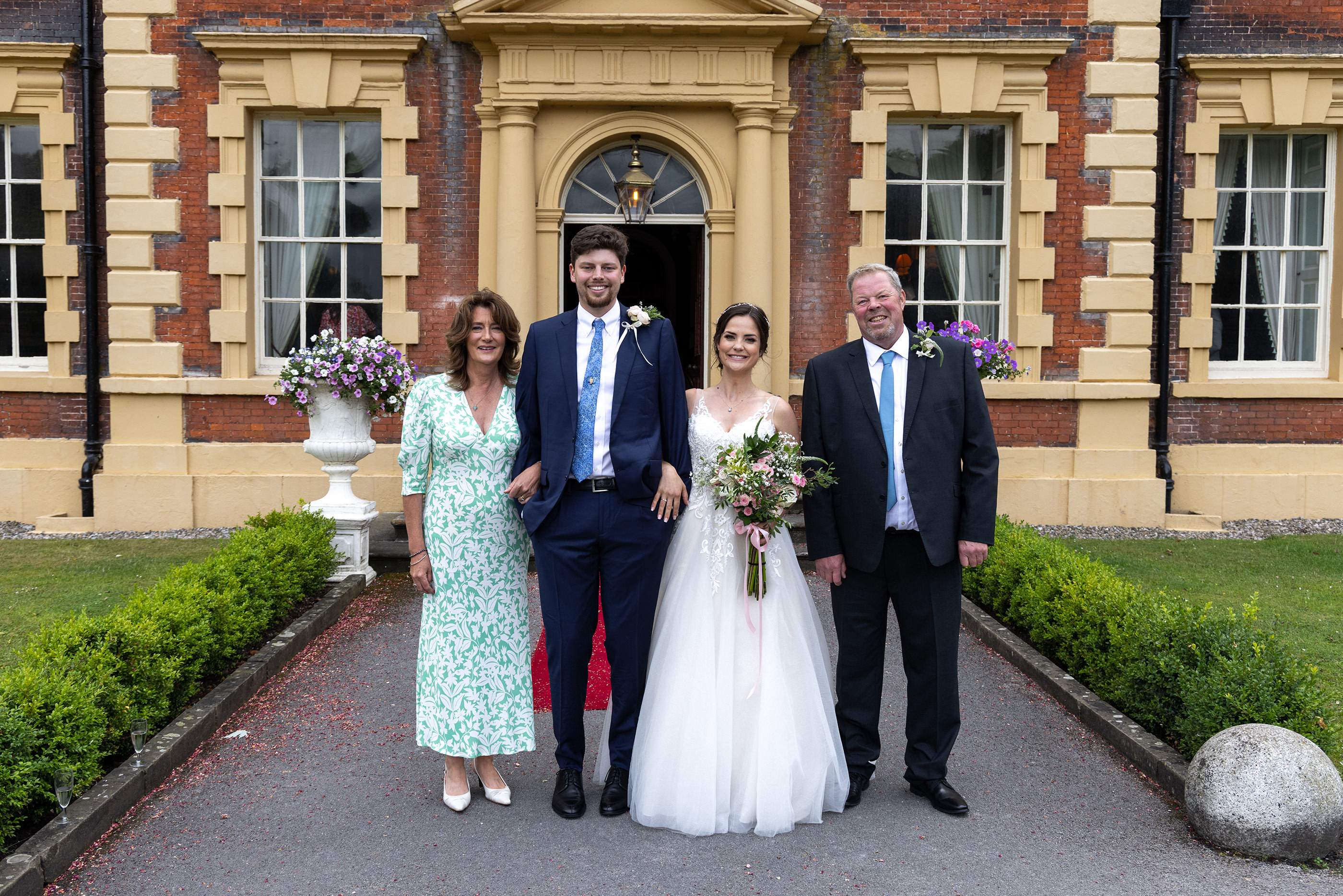 The bride and groom with his parents 