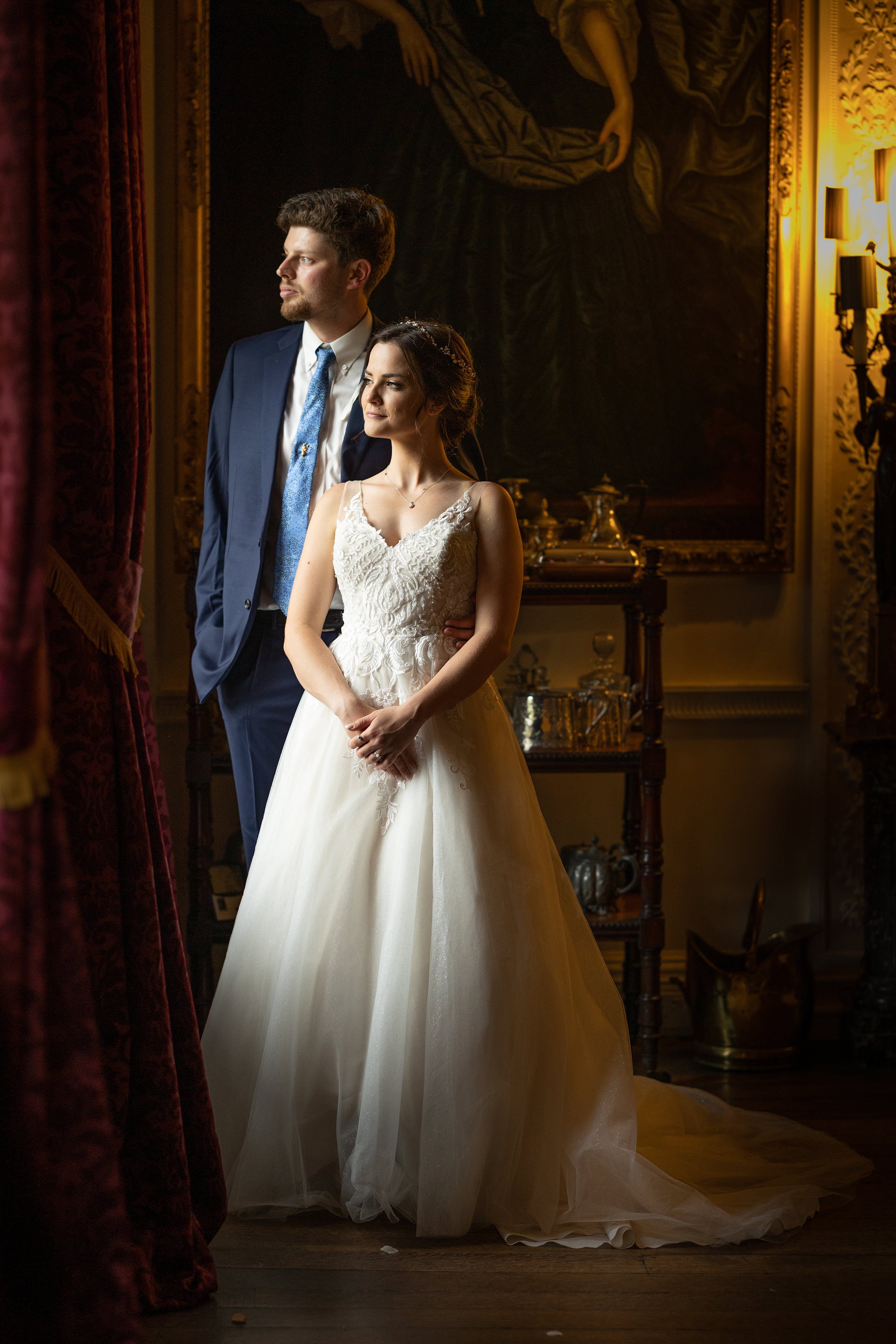 the bride and groom looking out of the window 