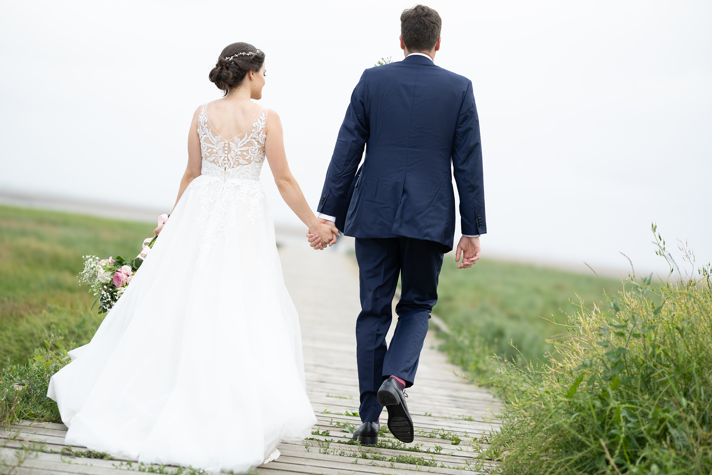The wedding couple go for a walk on Lytham jetty 