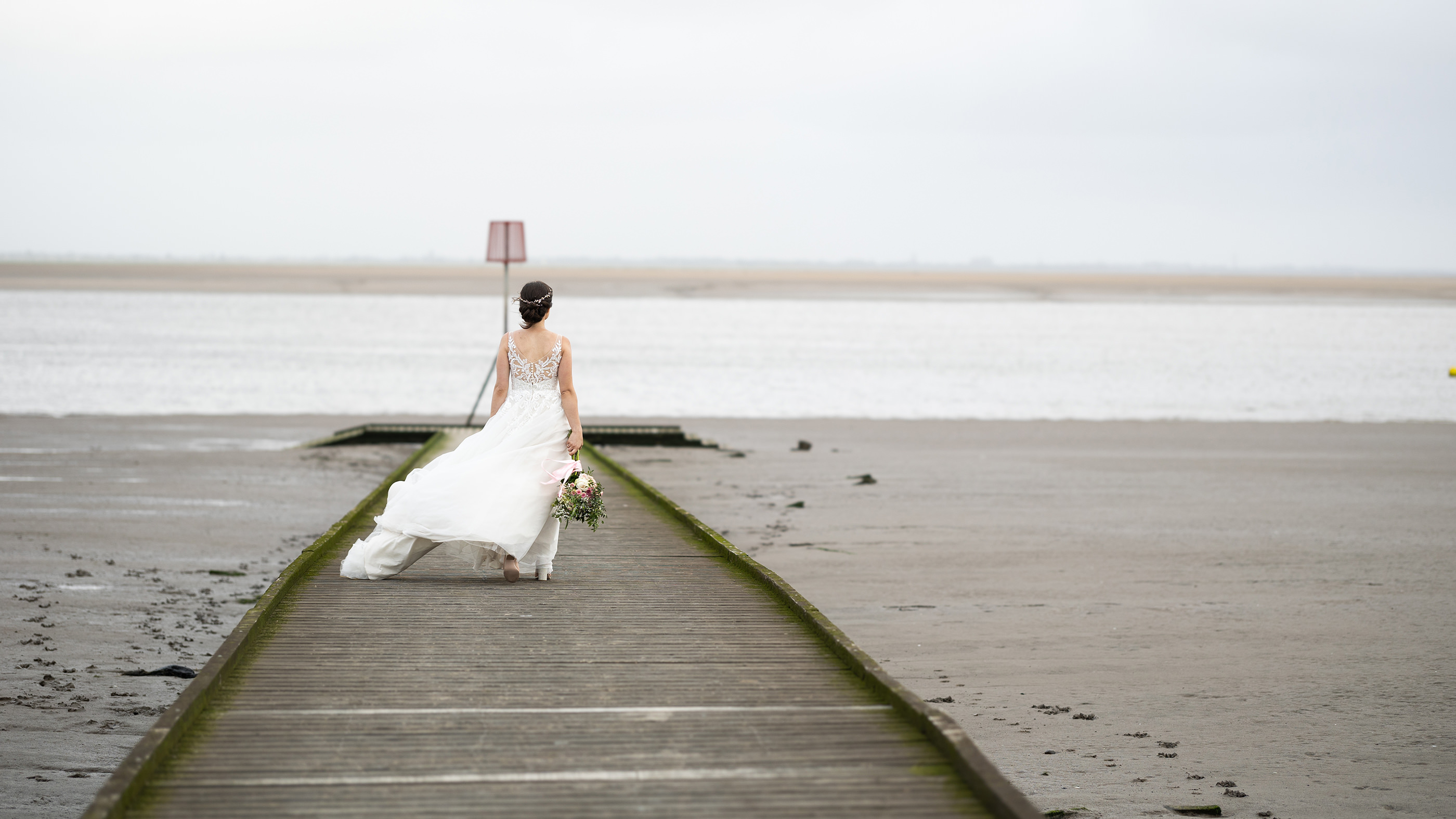The Bride walking down Lytham Jetty