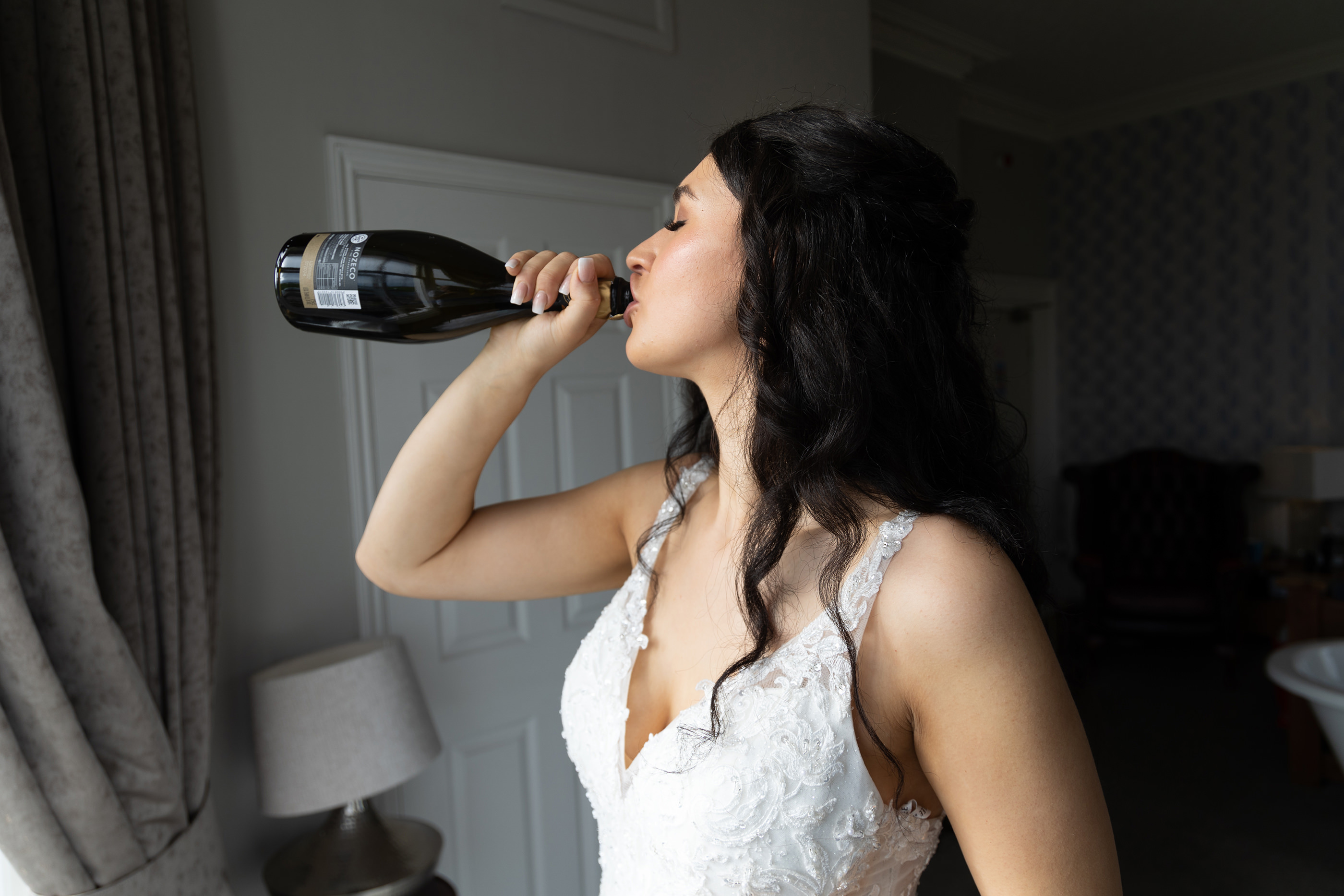 A quick drink of champagne before heading off for the wedding ceremony 