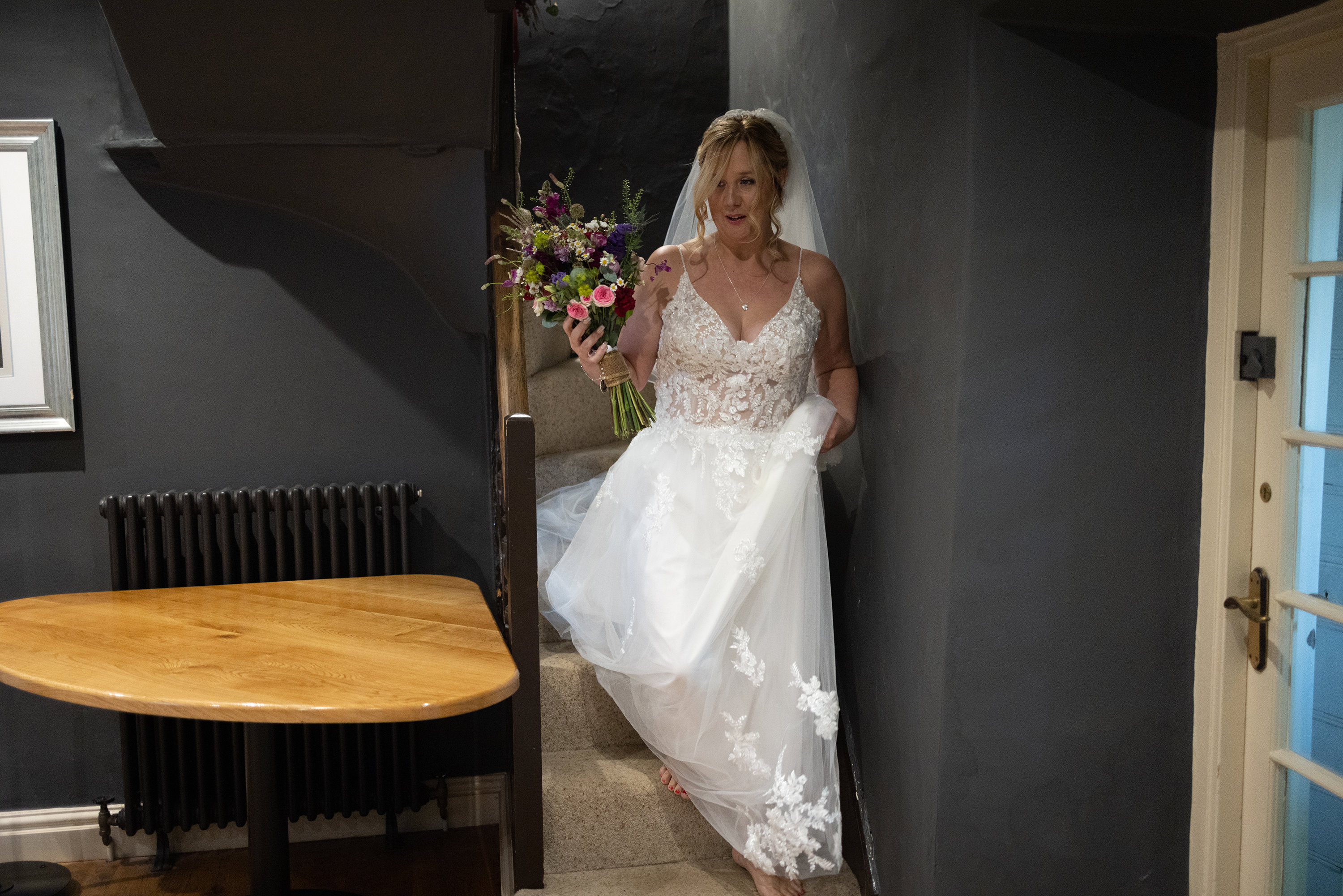 The Bride coming down the stairs at hipping Hall 