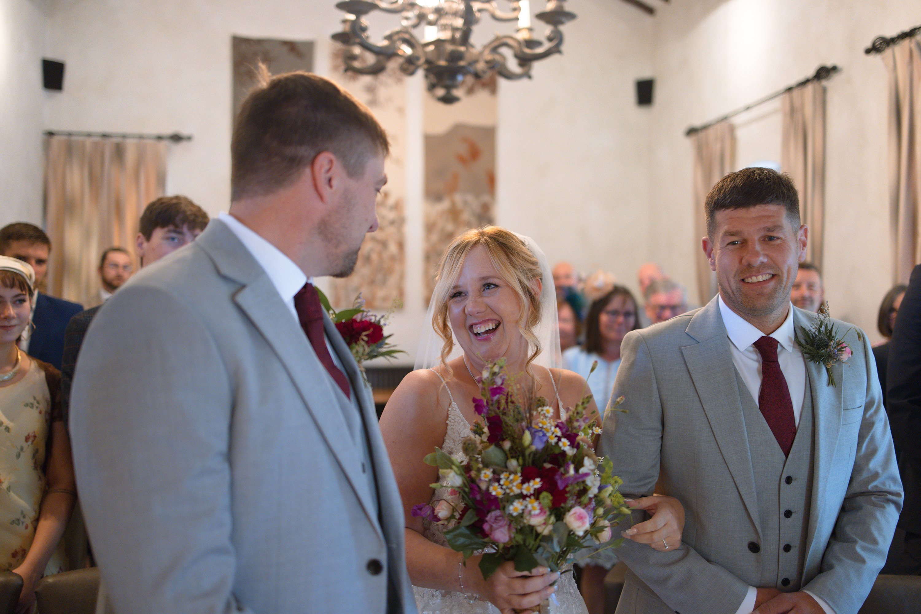 The bride and her brother walk in to the wedding ceremony 