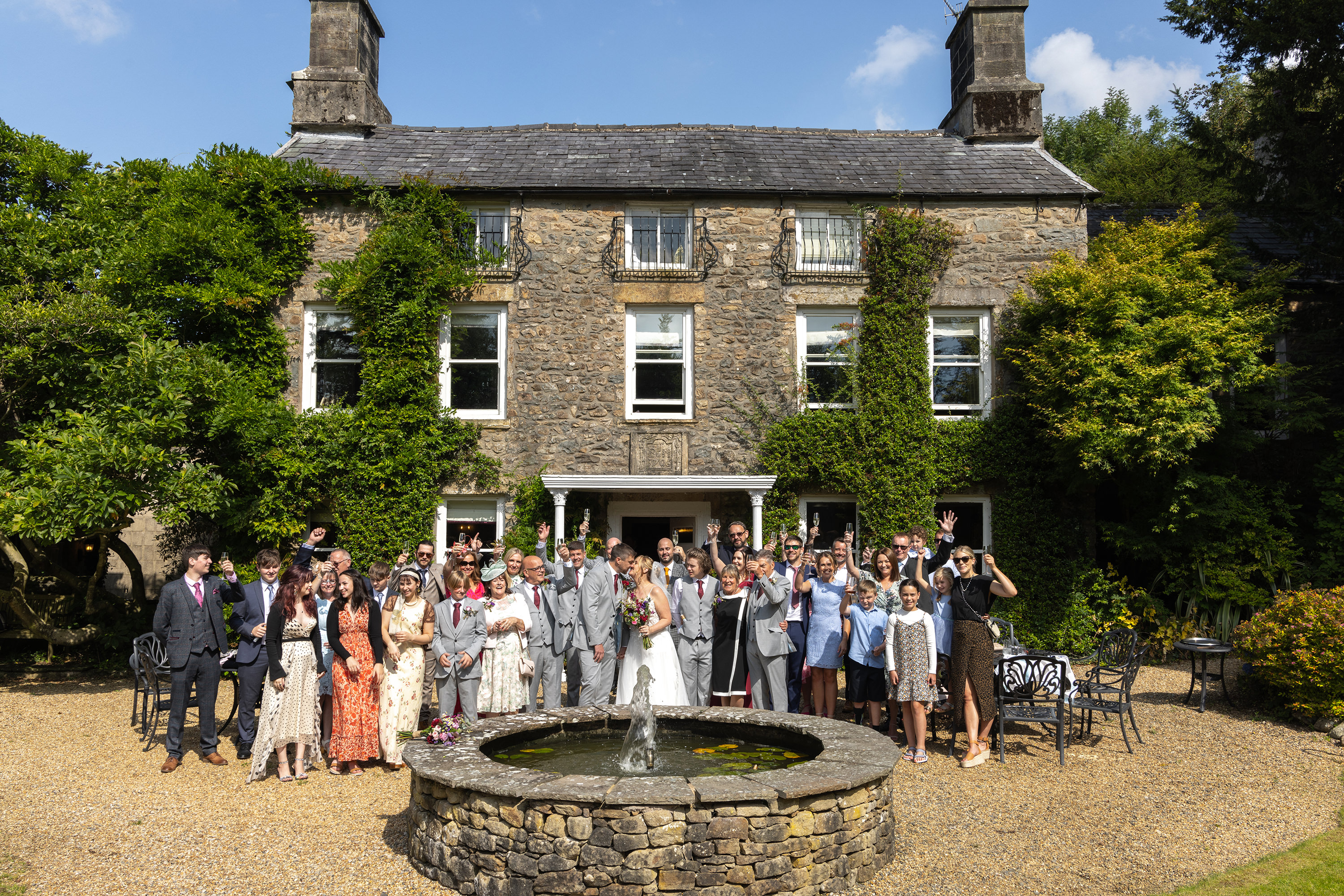 The bride and groom with all day guests at hipping Hall 