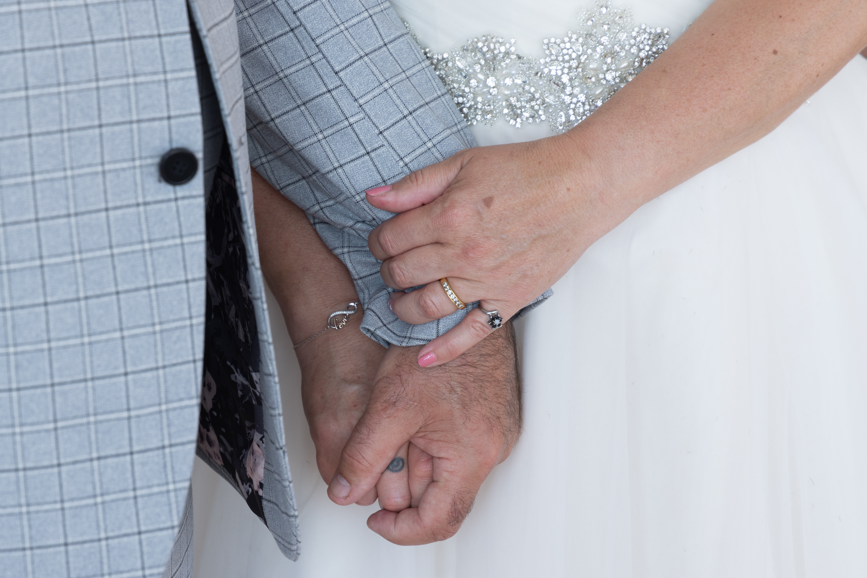 The bride and groom hold hands 