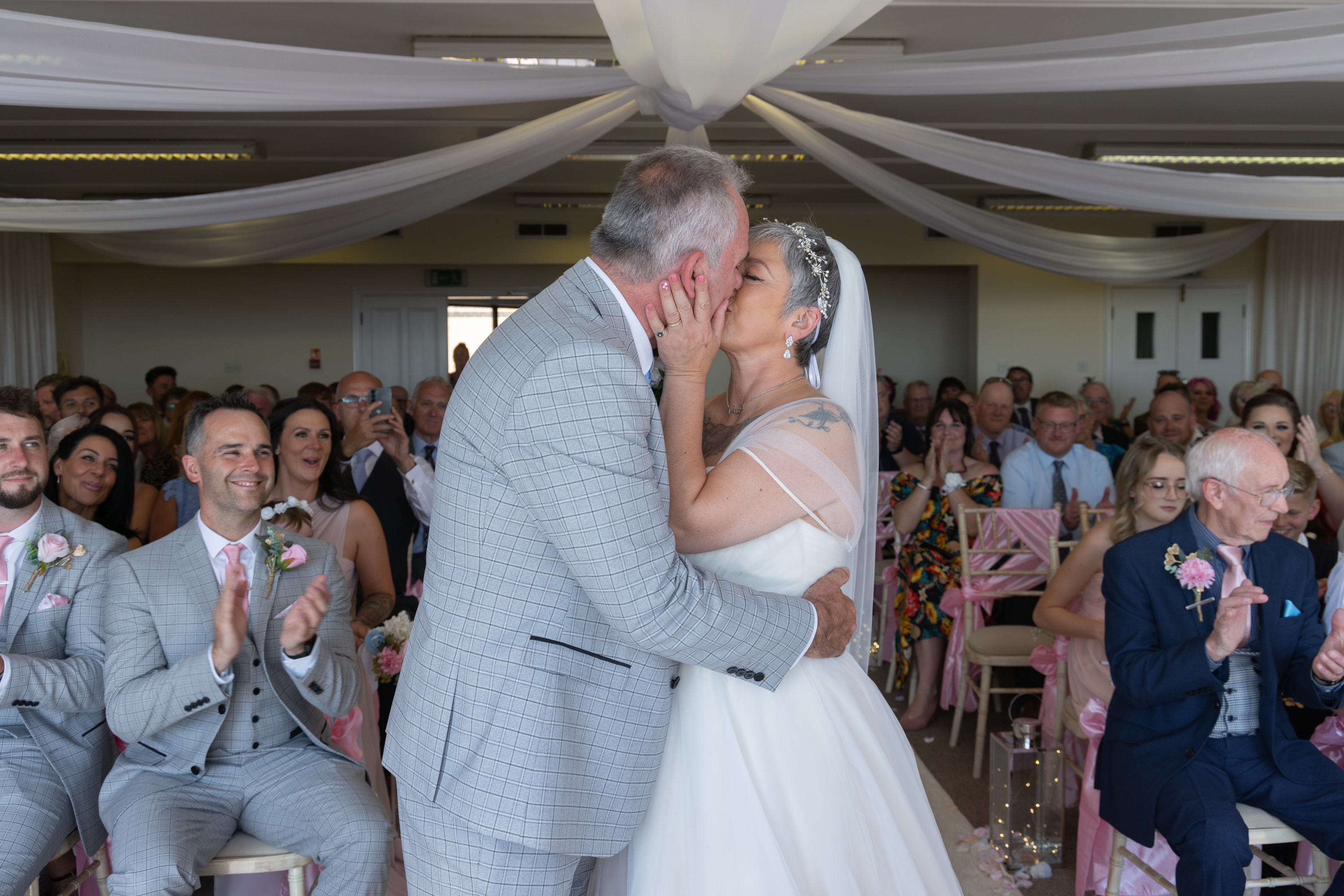 The bride and  groom seal the wedding with a kiss 