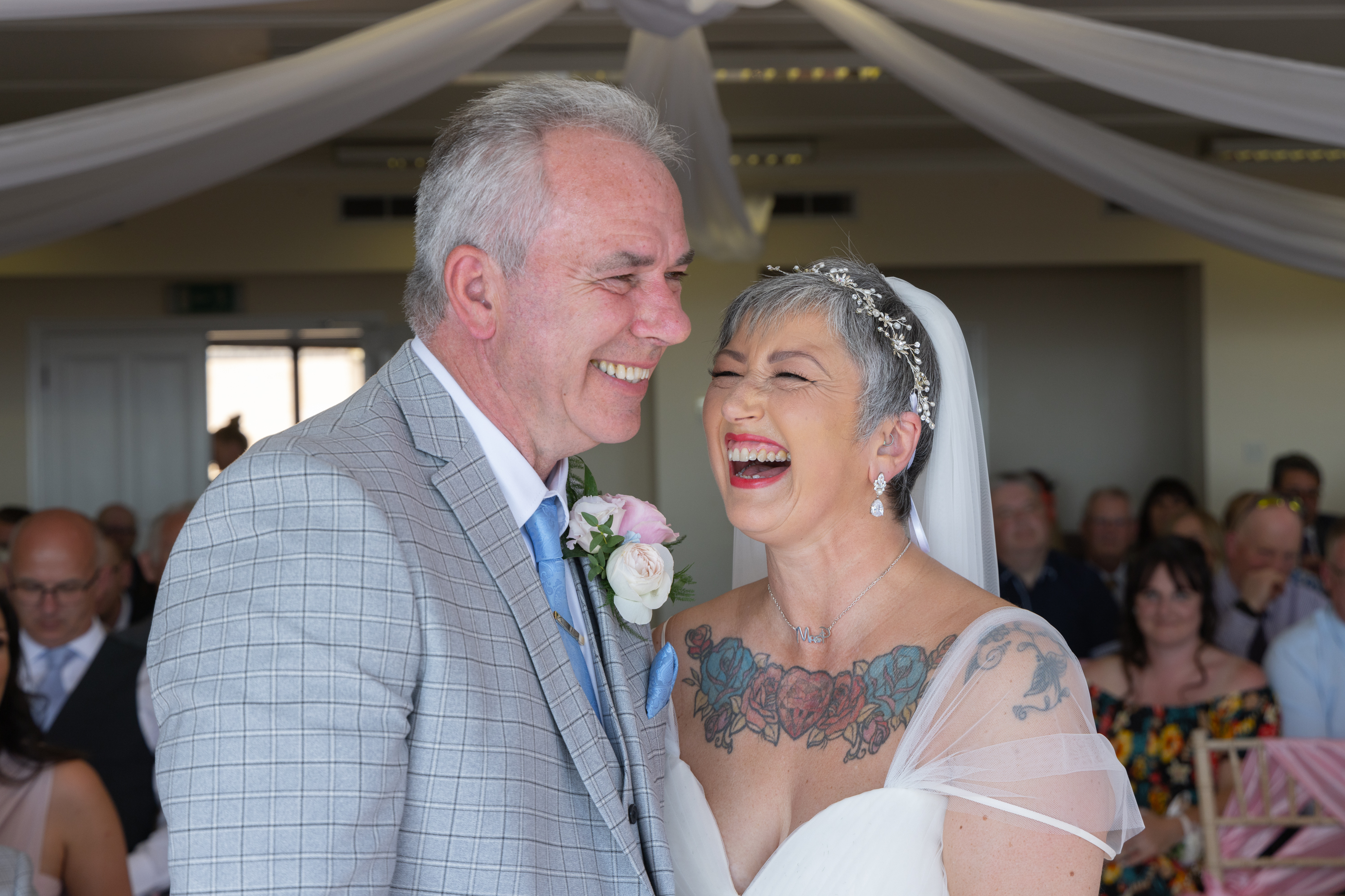 Caroline and Peter laughing at the end of the wedding 