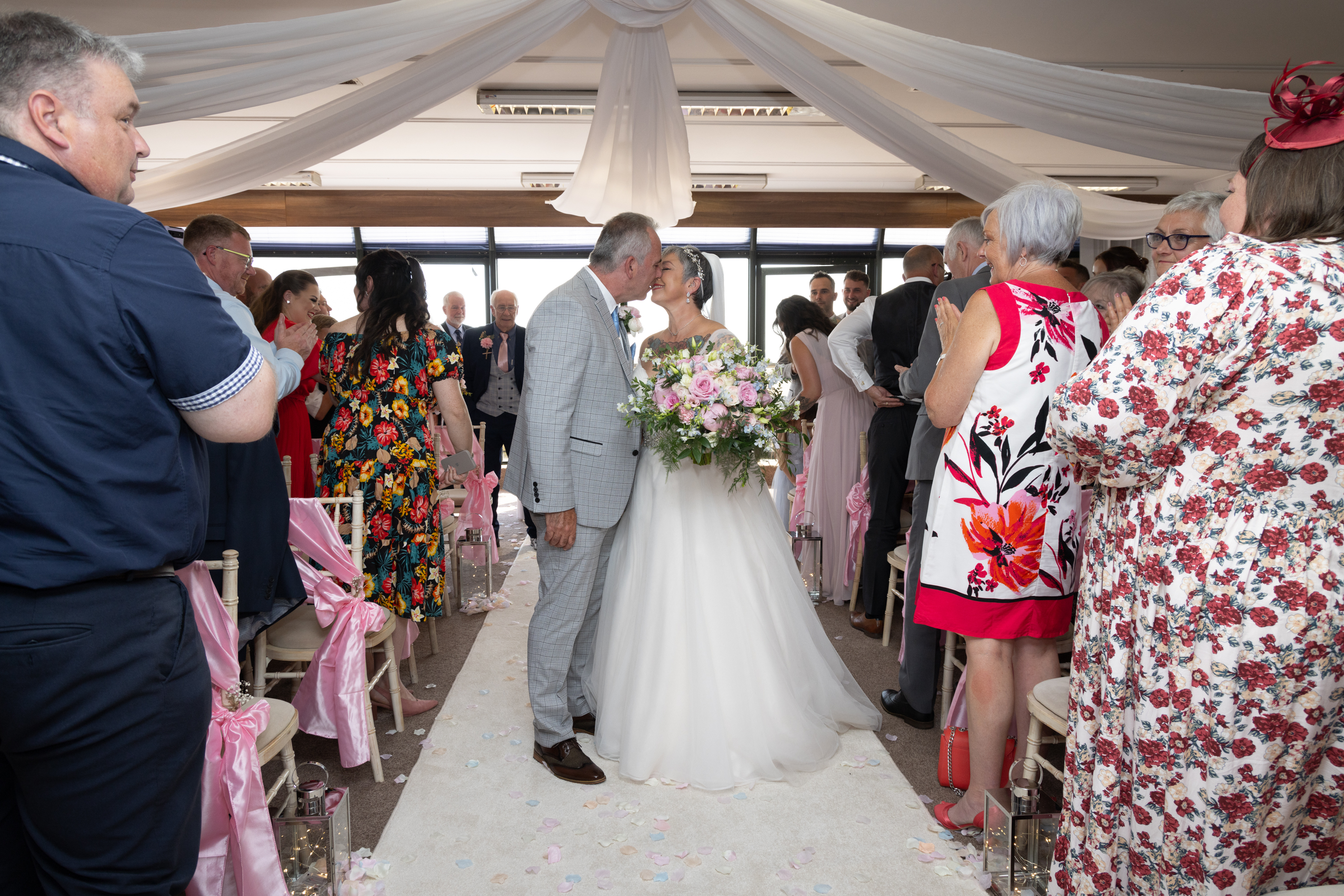 Caroline and Peter walk down the aisle 