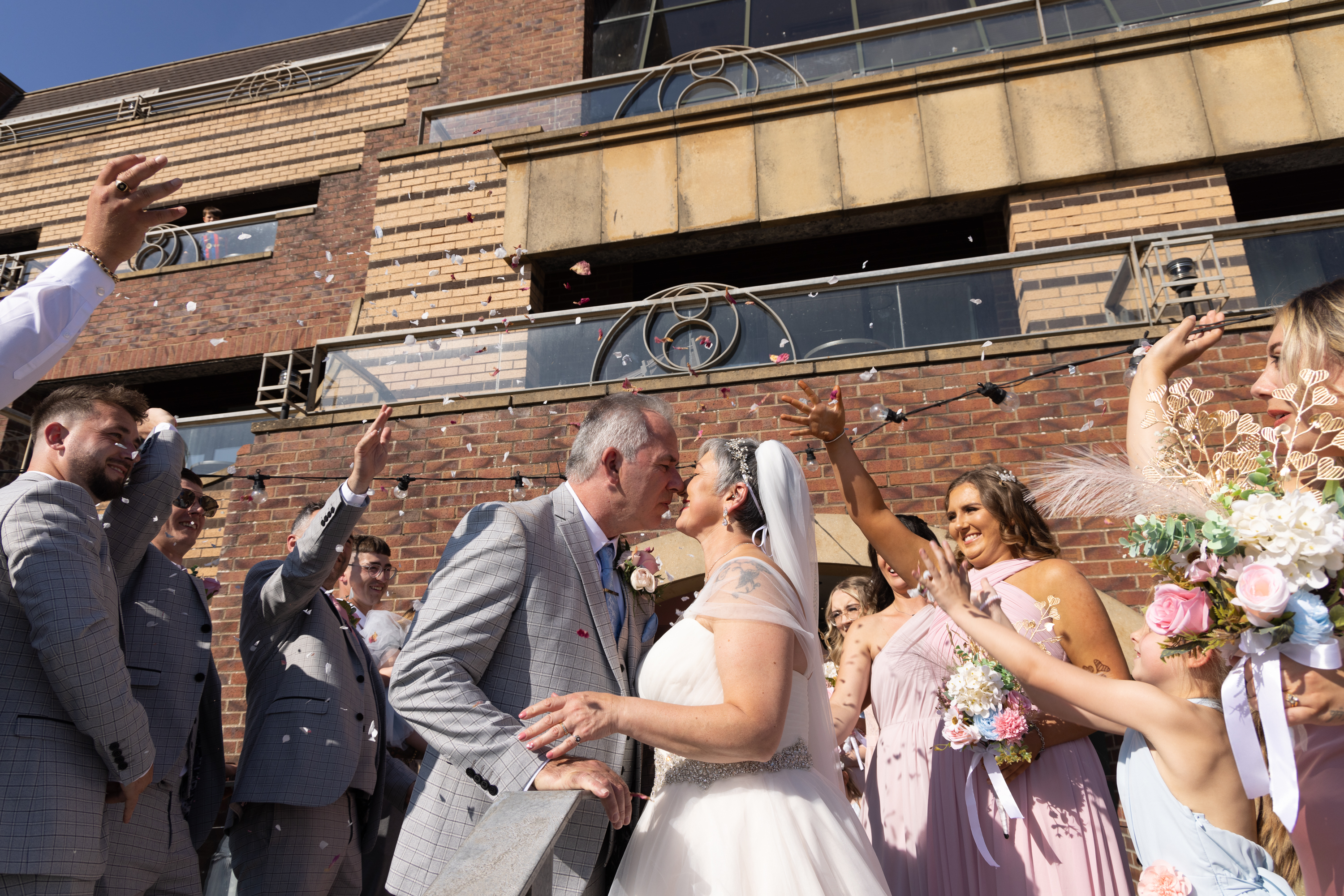 The wedding gifts throw confetti over Peter and Caroline 