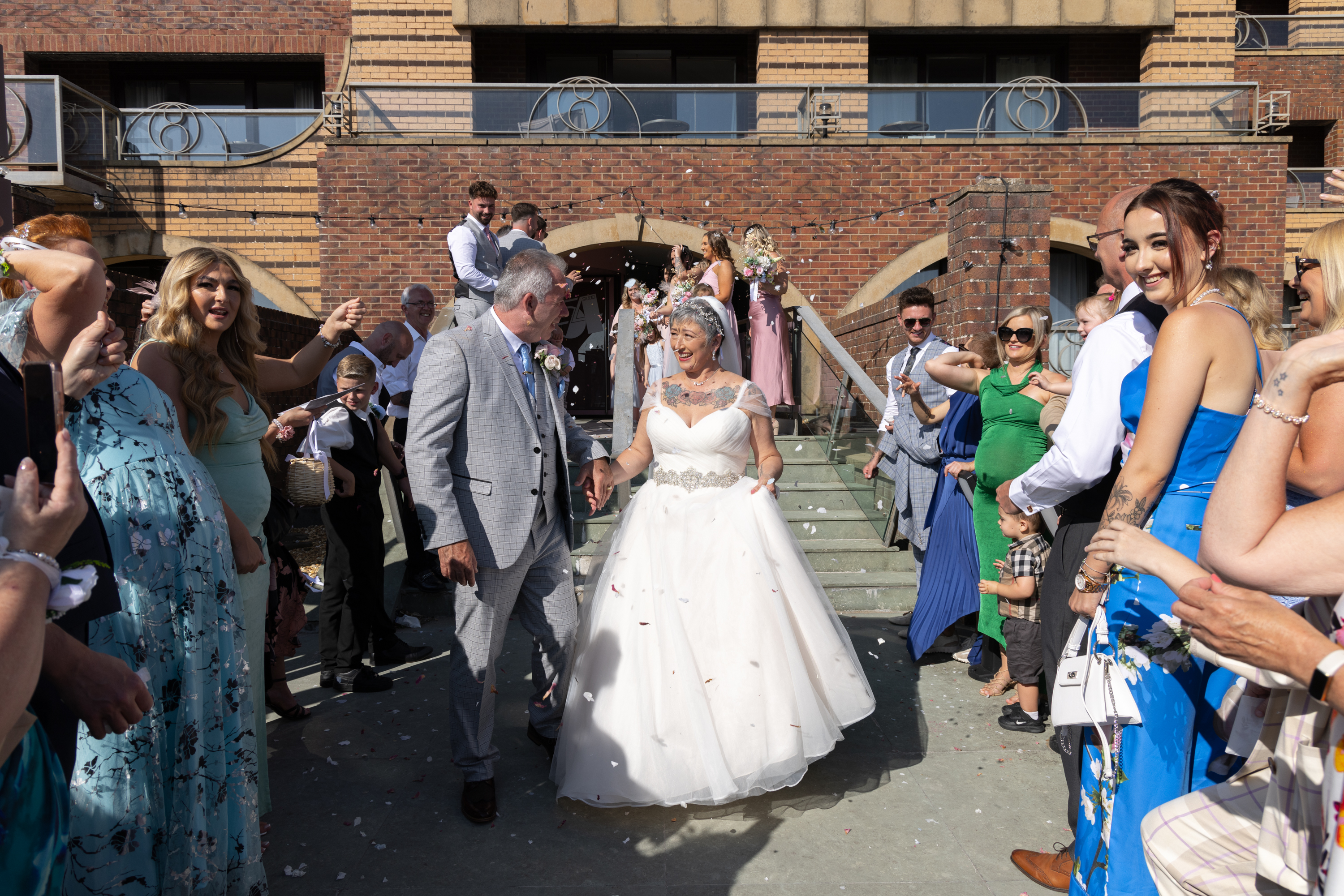 The wedding gifts throw confetti over Peter and Caroline 