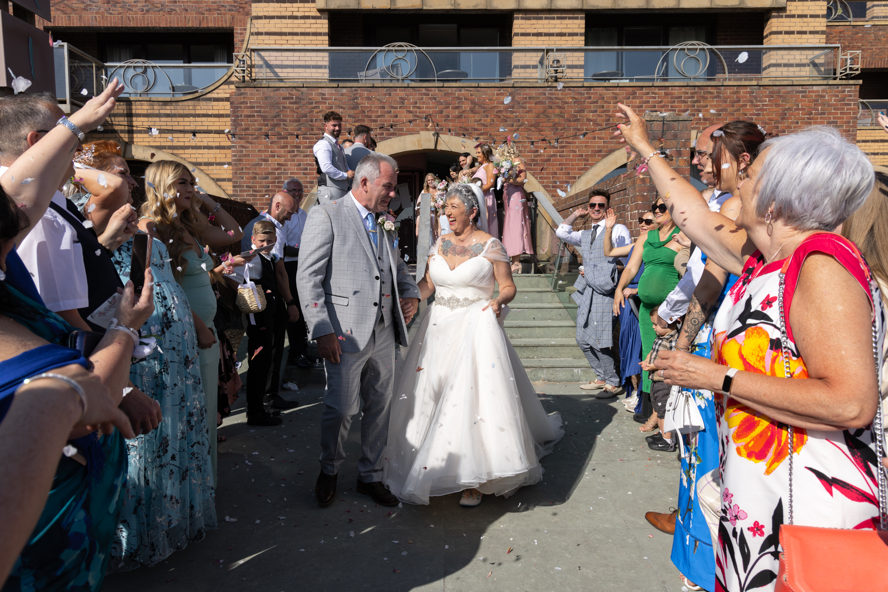 The wedding gifts throw confetti over Peter and Caroline 