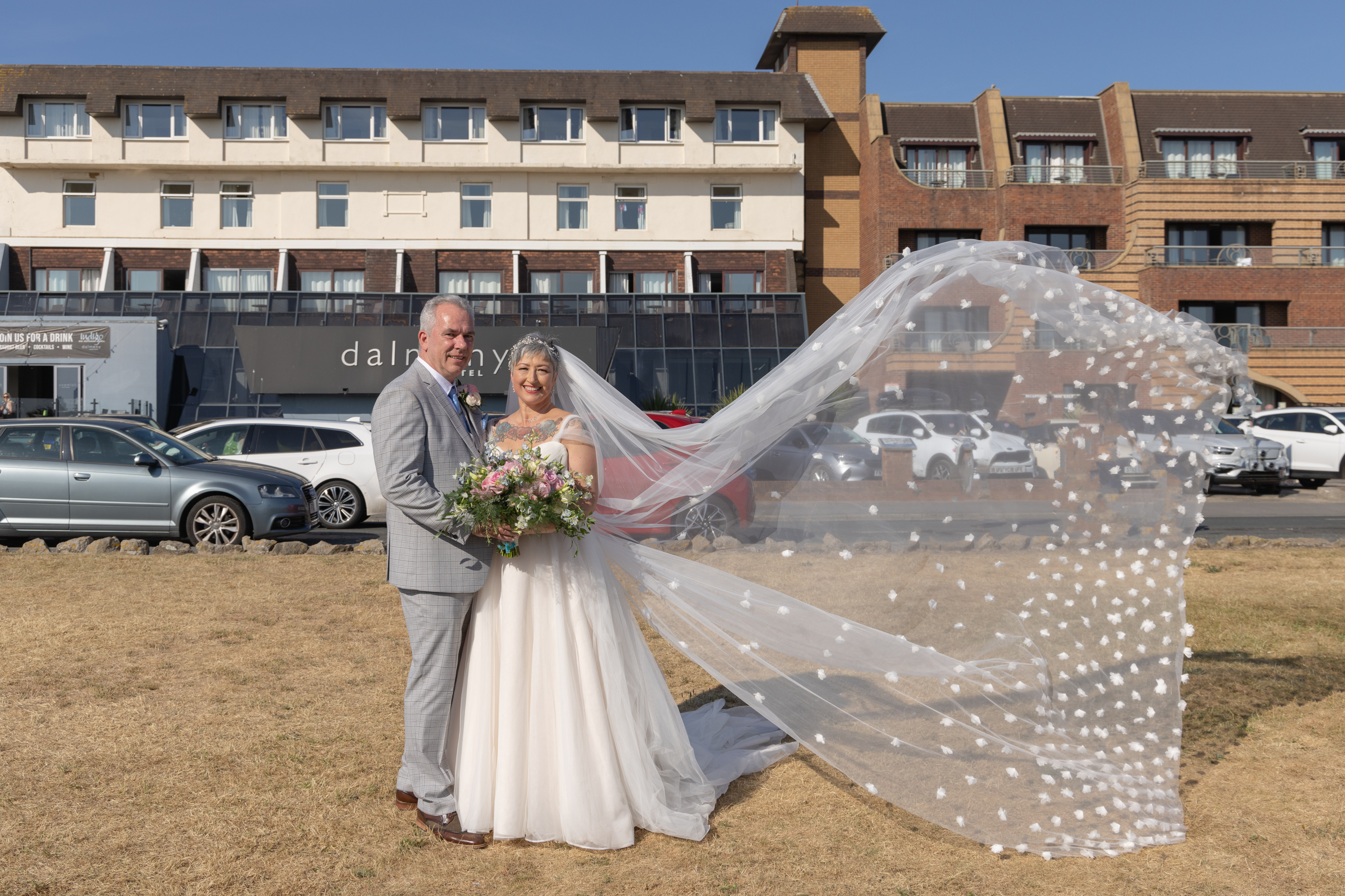 Peter and Caroline have their photo taken outside the dalmeny  hotel