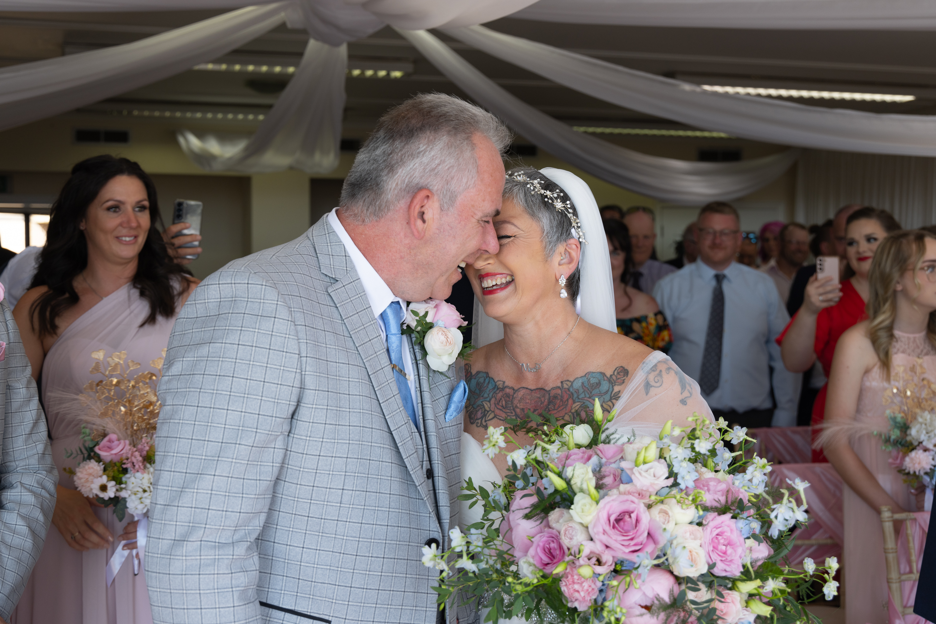 Caroline and Peter laughing during the wedding ceremony 