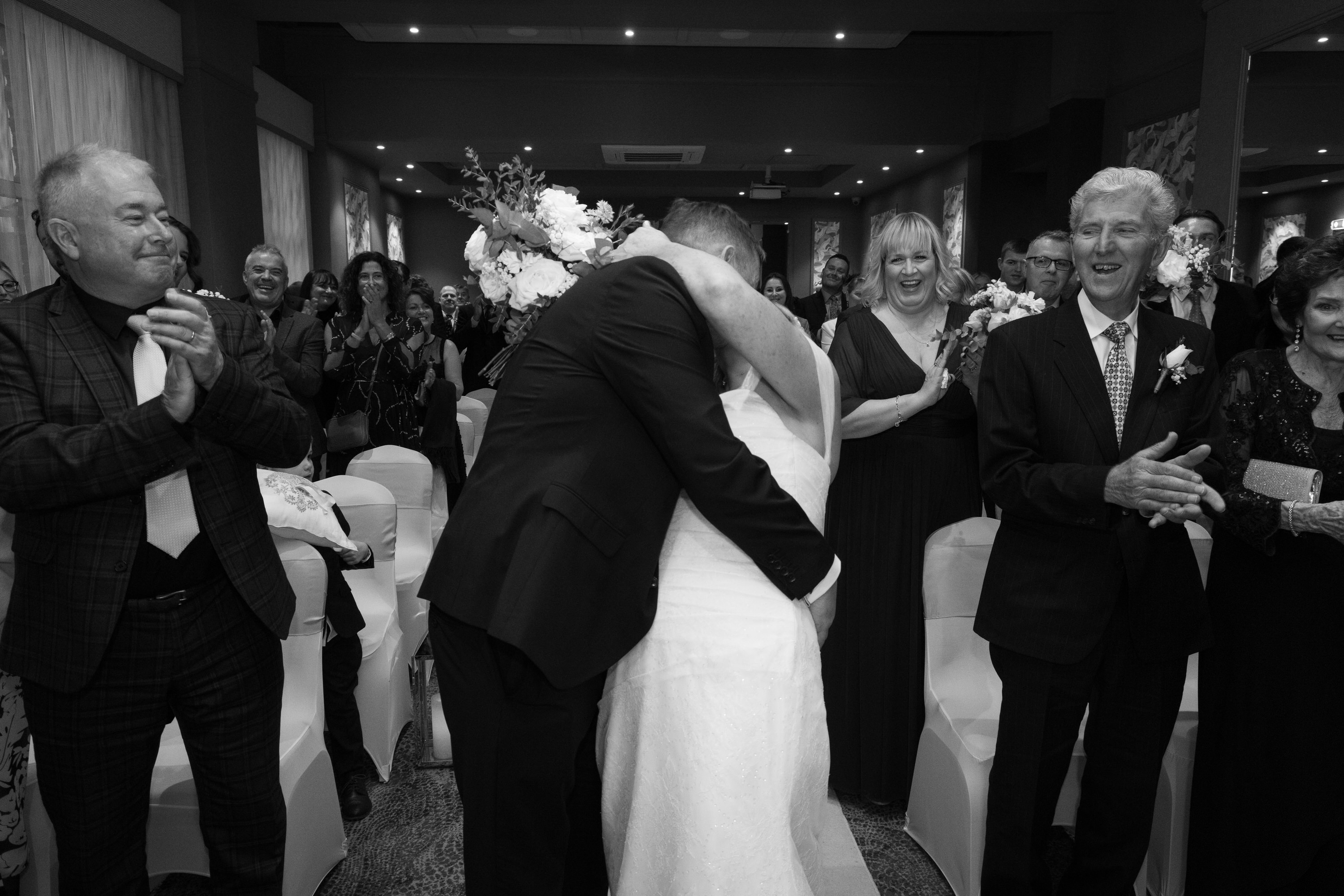 The bride and groom have their first kiss at the Clifton Arms Hotel in the lytham
