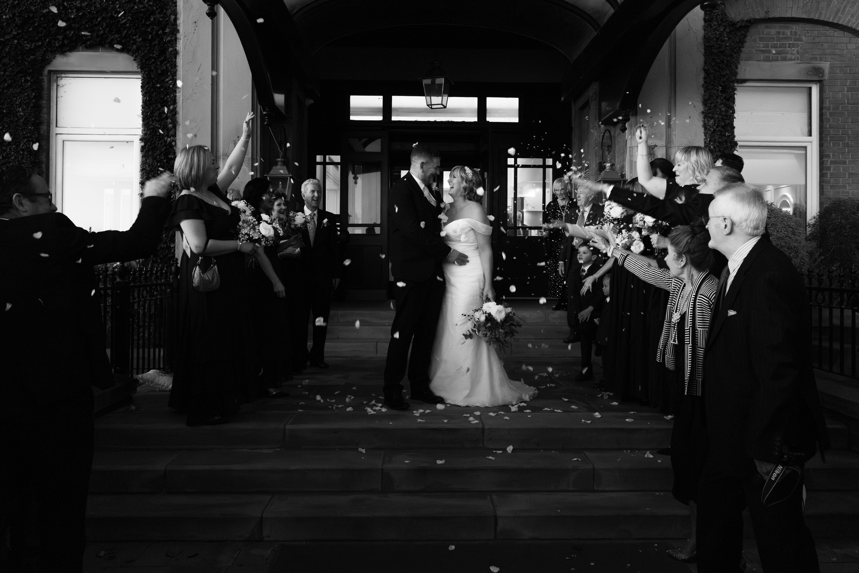 The bride and groom kiss on the steps at the Clifton Arms Hotel 