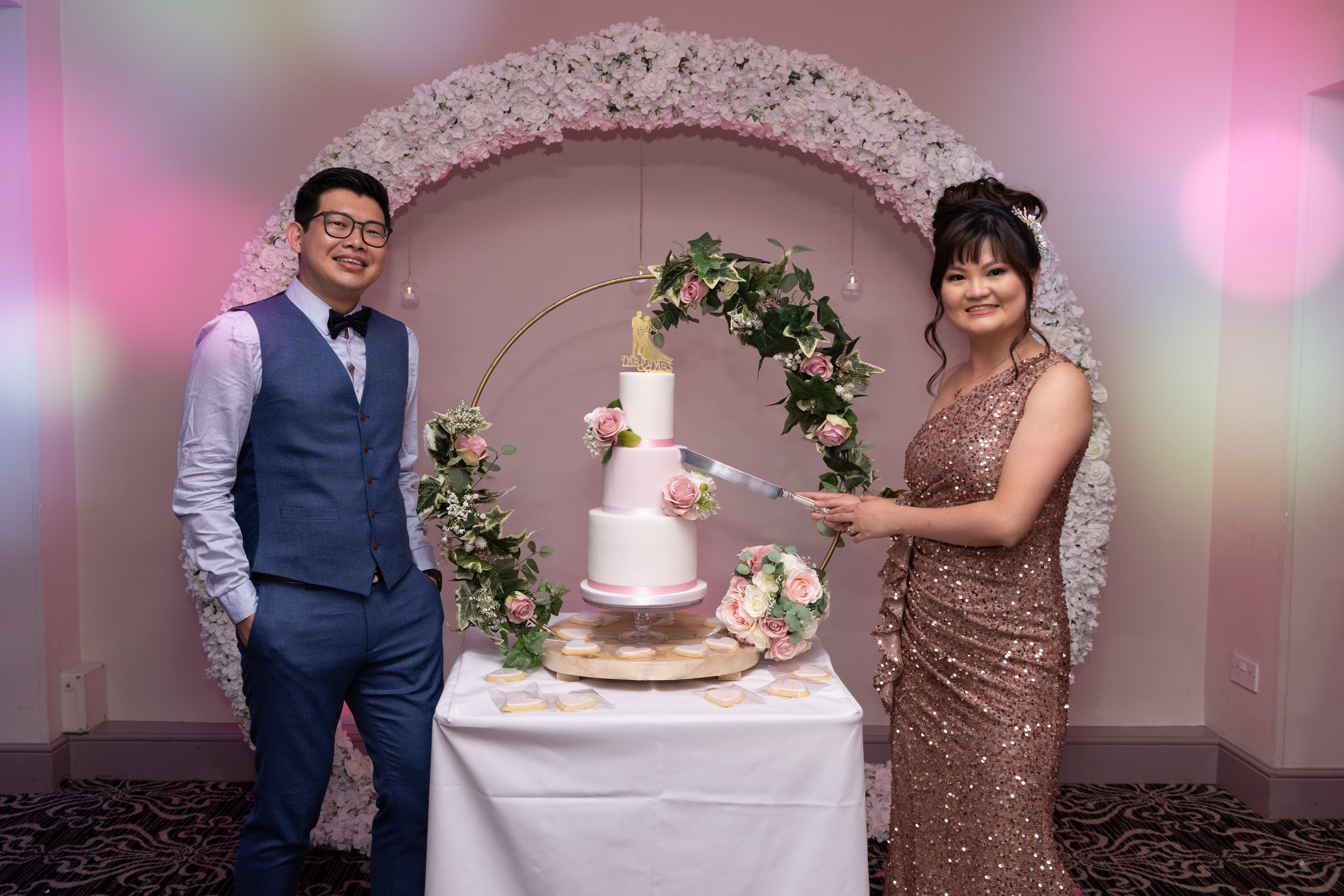 The bride and groom cut the wedding cake 